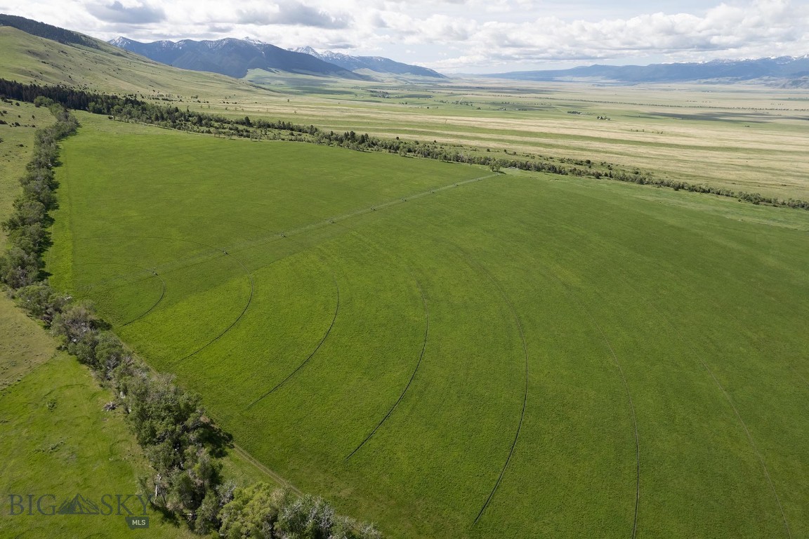 Nestled in the heart of one of Southwest Montana’s most coveted and scenic regions, MJS Ranch offers an exceptional opportunity to own 1,416± acres in the stunning Madison Valley, just outside Cameron and 20± minutes from the charming town of Ennis. This end-of-the-road property is bordered by 2.5± miles of National Forest and wilderness area, ensuring unmatched privacy and direct access to thousands of acres of pristine wilderness. From nearly every vantage point on the ranch, breathtaking panoramic views stretch across the Madison Valley and out to the towering peaks of the surrounding mountain ranges, creating a majestic and inspiring backdrop. The world-famous Madison River, offering blue ribbon trout fishing, is just 7± miles from the ranch entrance at the Varney Bridge Fishing Access.

The ranch is graced with over 2 miles of Tolman Creek and half a mile of Mill Creek, providing excellent water resources for stock and wildlife. The land is well-suited for productive agricultural use with approximately 100± acres under pivot and 50± acres under flood irrigation. It supports a viable cattle operation with capacity for 80 pairs, bolstered by two additional summer grazing leases.

Improvements on the property include a beautifully crafted 3,100± square foot main home, featuring three bedrooms, three and a half bathrooms, a home theater, and an attached two-car garage with ample storage. The secondary residence, a 896± square foot cabin, offers four bedrooms and two bathrooms, making it ideal for guests or a manager’s quarters. The ranch is well-equipped for equestrian and agricultural use, with an indoor riding arena housing seven stalls, a tack room, a barn, a hay shed, an equipment shop, and corrals.

Located just over an hour from Bozeman Yellowstone International Airport and Yellowstone National Park’s West Entrance, this rare offering balances serene seclusion with excellent access to Montana’s world-renowned amenities and landscapes.