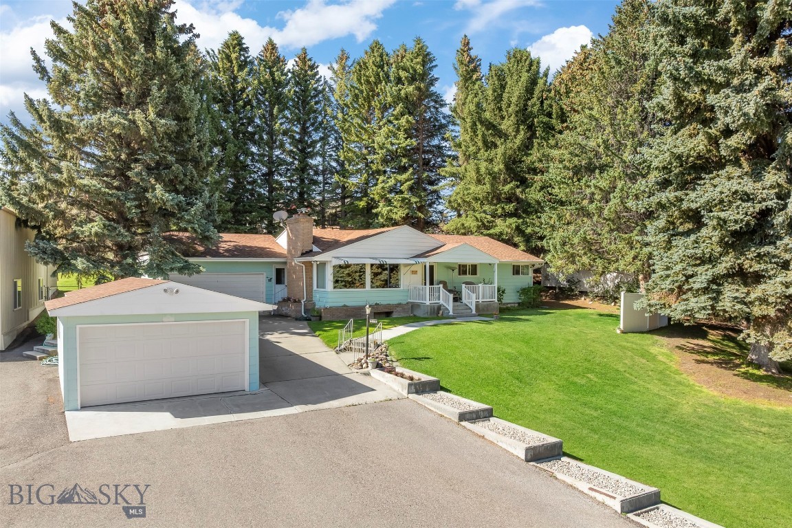 Stunning setting on over half an acre with breathtaking views and room to spread out! This meticulously maintained 5-bedroom, 2-bath home offers comfortable living space both upstairs and down. The main level features 3 bedrooms, a bright and inviting living area with abundant natural light, a spacious dining area, convenient main-level laundry, and ample storage. Relax and take in the scenery from the beautiful front porch. The lower level includes a large family room, 2 conforming bedrooms, additional storage space, and plenty of room for hobbies, guests, or entertaining. Outside, you’ll find an attached 2-car garage, a detached single-car garage, and an impressive 40’ x 60’ heated shop. The shop is equipped with underground air lines feeding several separate air stations, making it ideal for mechanics, hobbyists, RV owners, or anyone needing a functional workspace. The property also features underground sprinklers and irrigation water rights to the ditch that runs along the back of the property. With its combination of comfortable living space, incredible shop amenities, and peaceful setting, this property offers something for everyone.