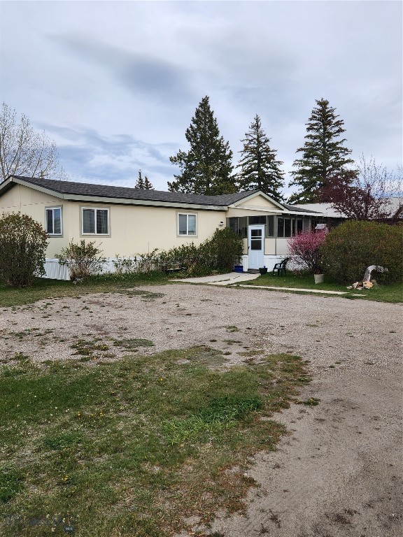 Large 4 lot parcel with over 1/2 acre in Lima, MT.  1998 Manufactured home has been well loved and very well cared for.  Enclosed  porches on both the front and back of the home almost doubling the square foot under roof providing many options from relaxation, hobbies, storage and more. There is plenty of storage inside and out with a greenhouse, a utility shed and garage/shop.  This property offers income potential with hook-ups for 3 RV'S or just utilize for your family and friends.  This property was once a showplace and could be again with just a little TLC.  Home has 3 bedrooms and 2 baths. If you are looking for a smaller parcel, this spacious lot may be split into two smaller homesites. The city water supply comes from a wonderful spring less than a mile from town. Lima is a small friendly, quiet town where folks are neighborly and watch out for each other.  There is a K-12 school, several churches and one of the best steak houses in Montana.  Major shopping is usually in Dillon, Idaho Falls, Butte or Bozeman.  With beautiful mountain views, this area is renown for outdoor recreation including hunting, fishing, biking, hiking, or scenic drives.  Lima is officially a " Continental Divide Trail Gateway Community."  Sum it up by saying, this property is the best bang for your buck.  It has 2 city water connection and consists of 4 city lots that can be divided, has 3 RV hook-ups for income or family and friends,  a well maintained home with large enclosed porches on both the front and back plus a beautiful yard with lots of trees and perennials. Additional highlights include the public use airport in less than 10 miles away in Dell, MT, great fishing and hunting nearby, along with hiking, biking and snowmobiling to name a few.  Within blocks of one of the best steakhouses in the state.  There is a critical access hospital within 60 miles. Lima is such a friendly and accepting town and it is easy to get to good shopping on I 15, both north and south.