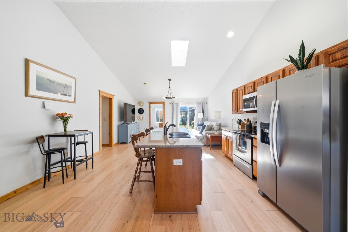 Welcome to this charming and thoughtfully updated condominium, offering the perfect blend of comfort, convenience, and low-maintenance living. With 2 spacious bedrooms and 2 bathrooms, this single-level home is ideal for a variety of lifestyles, whether you're looking for a full-time residence or a “lock-and-leave” retreat. Step inside to an inviting open floor plan enhanced by vaulted ceilings and abundant natural light, creating a bright atmosphere throughout the main living space. Recent updates include fresh interior paint, new white oak LVP flooring, and plush new carpet in the bedrooms, giving the home a clean, modern feel. The guest bathroom has also been tastefully updated with contemporary tile finishes. The kitchen, living, and dining areas flow seamlessly together, making the space perfect for both everyday living and entertaining. Outside, enjoy a private fenced yard/patio space just the right size for pets, or simply relaxing in your own outdoor space. A single-car garage provides convenient parking and additional storage. Located in a quiet, well-kept neighborhood, this condo is just minutes from the new Town & Country, the Marketplace, a variety of restaurants and shops, and Montana State University. With its ideal location and easy-care design, this home truly embodies a lock-and-leave lifestyle, giving you more time to enjoy everything that Bozeman has to offer.