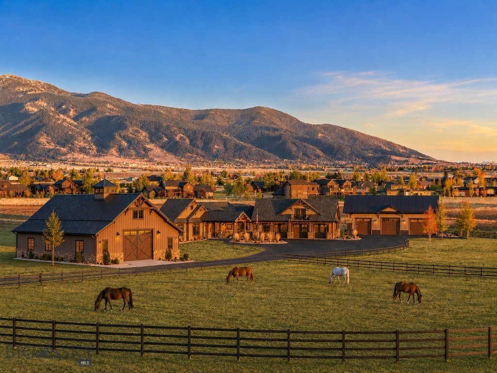 Discover the essence of Montana living on this remarkable 40-acre estate. Located within a gated community with an additional private, paved entrance through Spain Bridge Meadows, the property offers unmatched privacy surrounded by natural beauty. Residents enjoy community access to the Gallatin River along with walk and ride easements for effortless outdoor recreation. Inside, natural light fills the home through expansive windows that frame the mountains from nearly every angle. Beautiful timberwork runs throughout the main living areas, and a dramatic wood-burning fireplace anchors the great room. A beautifully appointed wet bar adds effortless convenience for hosting. The dining area opens fully to the covered patio through an accordion glass door, creating a seamless indoor–outdoor experience with an outdoor kitchen, wood-burning fireplace with gas starters, overhead heaters, a ceiling fan, and a hot tub, an ideal setting for year-round entertaining.The north wing includes an office, gym with rubber floor and the primary suite with expansive views, remote controlled blinds and a spa-like bath with a walk-through shower and tanning room. The south wing offers two bedrooms, a guest bath, pantry, laundry room, and access to the basement, garage, and attached guest apartment/suite- perfect for an au pair, multigenerational living, or long-term guests. A rare highlight is the fully equipped underground gun safe and 100 yard shooting range with vault door, pegboard gun holders, sound barrier, HVAC & ventilation system, retractable target system and camera system for target viewing, an extraordinary amenity that sets this property apart. With approval for up to three structures and room for four horses, the property offers exceptional flexibility. Just minutes from Bozeman, this estate blends luxury, privacy, and the wild beauty of Montana into a spectacular Montana sanctuary.
