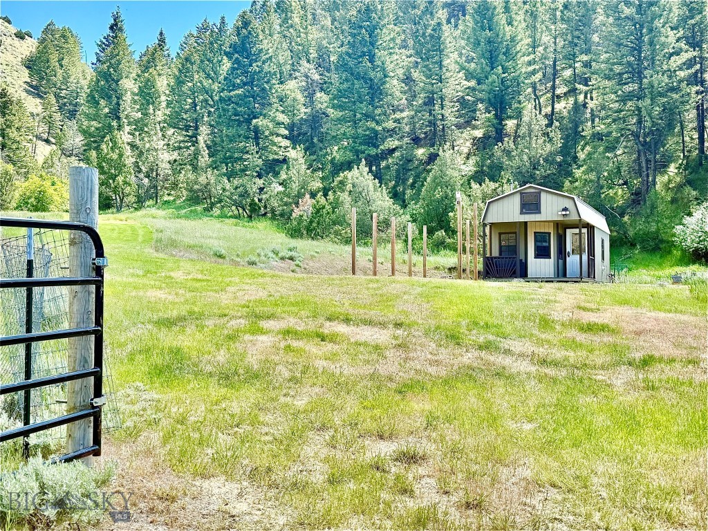 Fun off-grid cabin with solar system and developed spring on FORTY ACRES. A sweet MONTANA LIFESTYLE PROPERTY near Bozeman, Montana. Enjoy this OFF-GRID CABIN while you build your Montana dream home or use it for vacation, recreation, a family compound, hunt camp, or rental income. YEAR-ROUND ACCESS. The acreage is mostly wooded, providing excellent wildlife habit and privacy to hike and relax in nature. There are three separately deed lots totaling almost 41 acres. Cute pre-fab cabin sells furnished with indoor and outdoor furniture, appliances, and a wood stove heater. Off-grid system with solar arrays, batteries, a water holding tank (propane tank is leased) convey. The cabin is already prepped for a composting toilet. There is a nice, covered porch to enjoy the views and an existing RV pad. Have fun on the jeep trail runs up the hill to the upper elevations of the lots. The developed spring is located on the neighbors