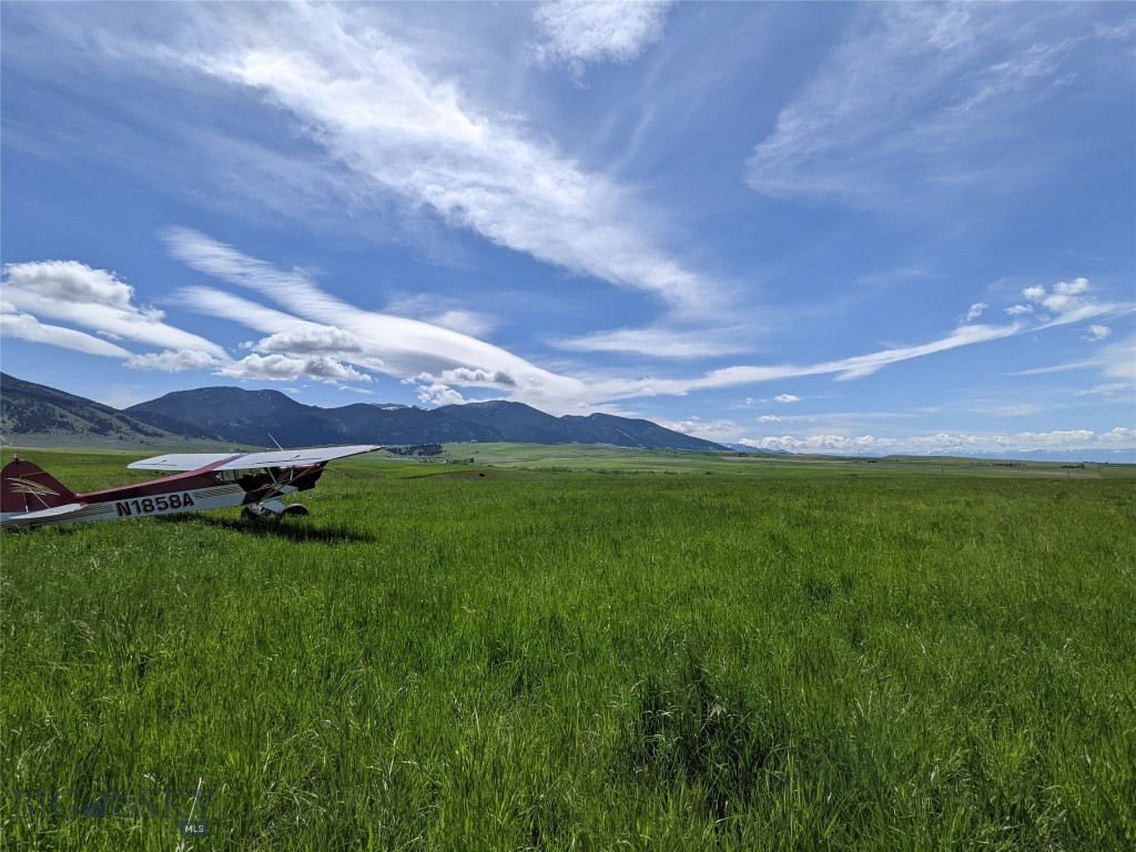 Exquisite Acreage with Unrivaled Montana Vistas! Discover a premier land holding featuring breathtaking, near 360-degree views of the Gallatin Valley, the Bridger Mountains, and the Tobacco Root Range. This versatile property boasts dual-access frontage from both Pass Creek Road and Haugland Road, providing exceptional convenience for development or agricultural transport. Currently used for hay production and grazing the land serves as a natural corridor for local wildlife, offering elite recreational opportunities. Outdoor enthusiasts will appreciate the property's proximity to thousands of acres of National Forest. For the private pilot, the expansive topography provides ample space for a single-engine aircraft operations. A designated building envelope is already established, strategically positioned to maximize the site’s natural beauty and ensure an optimal residential footprint. *boundary lines in the pictures are approximate.