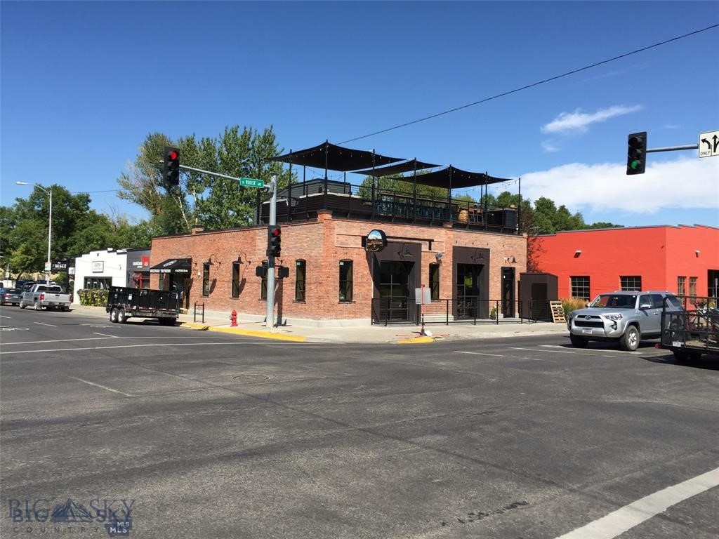 Introducing the Iconic Bozeman Taproom building for sale. This historic Bozeman Building received the Bozeman Beautification Award in 2016 for after an extensive remodel. The remodel included a completely new steel internal structure, new foundation and concrete floor, new walls, electrical, plumbing, HVAC, fire suppression system, rooftop, windows, doors, etc. the only part of the building that was saved was the original exterior brick and the some of the interior ceiling joist/timbers. The building includes two separate spaces; the Taproom Bar and a smaller separate office/retail space currently being used as a Real Estate Brokerage. This sale does not include either of the businesses. Both spaces are currently leased. The Taproom just renewed their lease for an additional 5 more years with two more consecutive options thereafter. The Real Estate Brokerage’s current Lease ends July 1st 2026. The leases are both a true Triple Net; the tenants pay all taxes, common area expenses, utilities, garbage, etc. Rents total 91,822.44 with a 3% annual escalator. If your looking for a property with some serious upside there is the potential to turn the office/retail unit into a “Speak Easy” Bar and/or liquor store by utilizing the full Liquor License from the neighboring Taproom. This would have to be negotiated with the owners of the Taproom business but they are completely open to the idea. The Taproom Restaurant and Bar has a main floor area that is approximately 2700 SF with an additional 950sf of rooftop deck and patio space. The owners of the Taproom bar have expressed interest in enclosing the rooftop patio to create a year round space. There is also a small ~300 sf basement that is used for food storage, utilities and a dish washing area for the restaurant. The separate office/retail unit is approximately 1050 sf which includes its own full Kitchen, a bathroom, and 3 small offices with a large open office area. The office has its own heating and cooling but shares water and sewer. If you are looking for a very stable worry free investment in downtown Bozeman properties like this don’t come around very often.