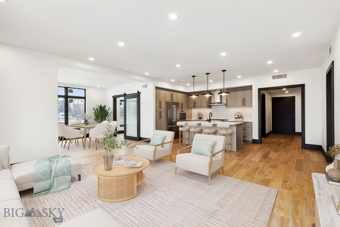 The Henry, a six-story luxury condominium building in Downtown Bozeman, #207 has a bright and airy feel to it. Sitting on 1,886 SF with two bedrooms, plus den, two and a half bathrooms, and a 122+- SF heated balcony, this unit has it all. With engineered oak hardwood floors, wool carpeting, quartz countertops and Bosch appliances to go with high-end fixtures and tons of natural light, this condo is a ready-made luxury offering in the heart of the Rocky Mountains’ coolest town. And it doesn’t stop there - The Henry building has amenities that make it more than just a residence: a ground floor fitness center, a private, landscaped courtyard and climate-controlled, secure underground parking. Just three blocks from Main Street, twenty-five minutes to Bridger Bowl and forty-five minutes to Big Sky Resort, you'll have easy access to the vibrant downtown scene, outdoor recreational activities, and Montana's stunning natural landscapes.