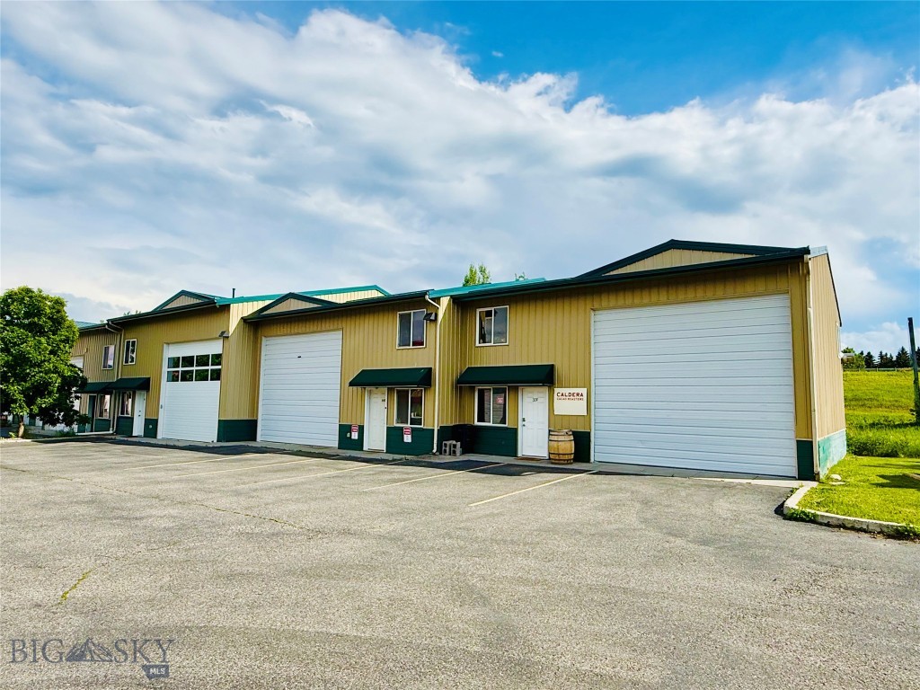 Owner occupy or investment opportunity for a light industrial commercial condo in East Bozeman.  Located just off East Frontage Road allows for easy access from the East Main Interchange of I-90.  Large overhead door leads into the warehouse space, and a man door leads into office/showroom.  Additional rooms on the ground floor allow for offices or extra storage.  Nicely finished upstairs has private windowed office and additional work space.  Also available for lease at MLS# 412696.