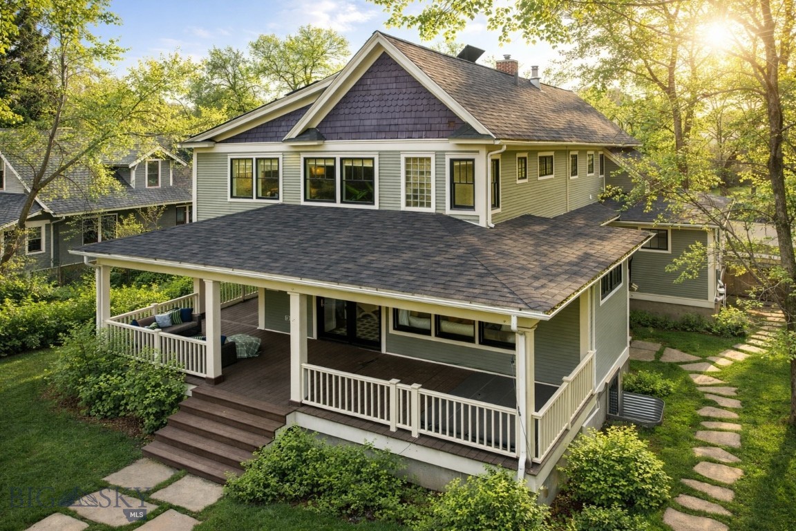 Located on one of Bozeman’s most coveted downtown streets, this charming residence on Willson Avenue sits just moments from Main Street and directly across from the historic Story Mansion. Blending early 1900s character with thoughtful, modern updates, the home offers a timeless yet elevated living experience. Inside, original hardwood floors, radiant heat, and freshly repainted interiors create a warm and inviting atmosphere. The remodeled kitchen is both functional and distinctive, featuring stainless steel appliances, an induction range, trash compactor, pantry, and a unique rotating wood-burning stove. The main level also includes a flexible office with front porch access, a spacious bedroom with a large closet, a dedicated dining room, and a powder bath. A secondary main-level living room opens to a wrap-around porch with a sunken hot tub, creating seamless indoor-outdoor flow. Upstairs, the light-filled primary suite offers soaring ceilings, multiple generous closets, and a beautifully updated en suite with a clawfoot tub, double vanity, and tiled shower. Two additional bedrooms, a full bath, and upstairs laundry provide comfort and flexibility. Outdoor spaces are designed for both relaxation and entertaining, featuring an expansive deck, underground sprinklers, and a detached garage. Additional upgrades include updated windows, new flooring, and solar panels, enhancing both efficiency and long-term value. A rare opportunity to enjoy historic charm, modern comfort, and one of Bozeman’s most desirable locations, just minutes from Montana State University and the energy of Downtown Bozeman.