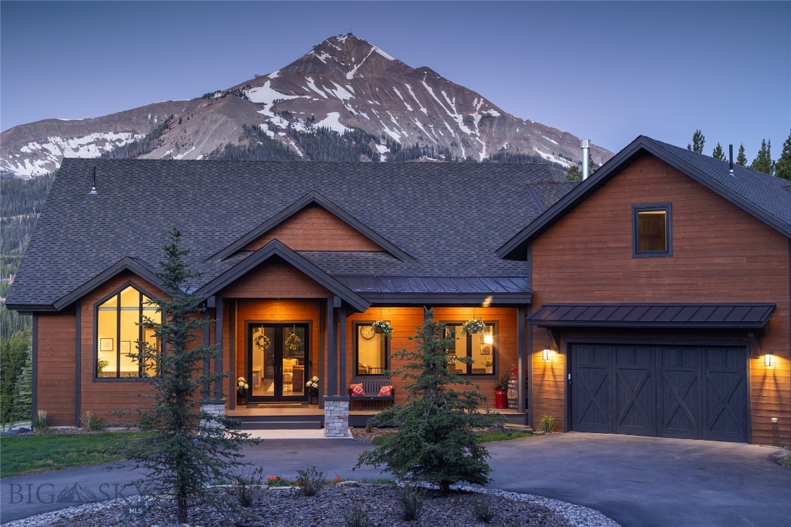 Ski-in, ski-out access meets effortless summer living at this elegant Cascade neighborhood home, tucked at the end of a quiet cul-de-sac among 1.519 wooded acres. Offered fully furnished, the home is ready to enjoy from day one, whether you're arriving for a ski weekend or a long mountain summer. The vaulted great room fills with natural light and framed views of iconic Lone Peak, while two distinct gathering spaces, each anchored by a fireplace, give guests and family plenty of room to spread out. The gourmet kitchen is built to host, with custom cabinetry, an oversized gas range, panel-front refrigeration, solid surface counters, and a generous island. Outdoor living is a true highlight. Spacious covered decks, a private hot tub, and a gas fireplace set the scene for cool evenings under the Montana sky, all surrounded by mature trees and the natural mountain landscape. The main-floor primary suite occupies its own private wing, and a dedicated ski room with lockers and a gear dryer sits conveniently on the main level with direct trail access. A bonus suite above the garage offers a quiet retreat for guests, while the lower level delivers a rec room, wet bar, bunk room, and two additional bedrooms with walkout access to the patio. Minutes from Big Sky Resort and the emerging One&Only, this fully furnished home pairs true ski-in, ski-out convenience with a layout designed for comfortable four-season living.