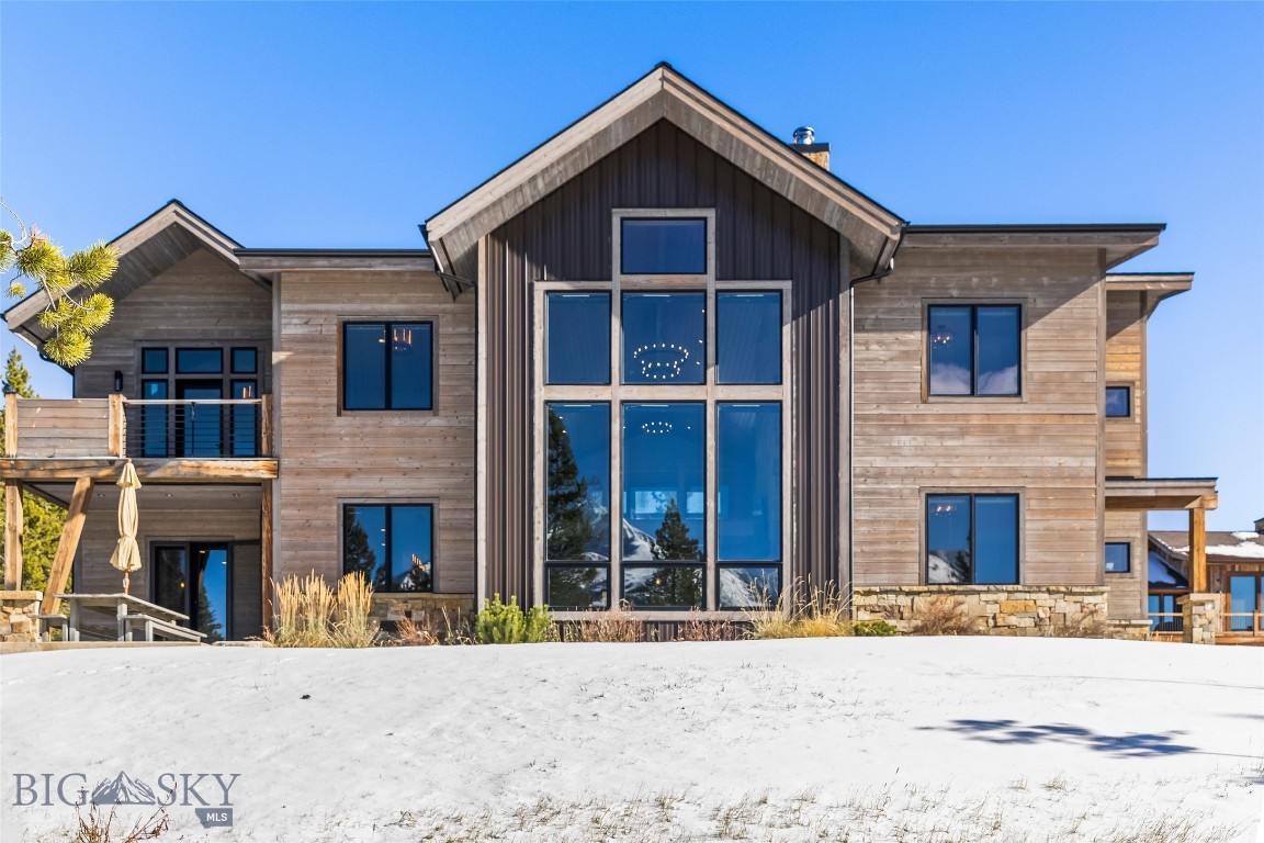 This is truly a skier’s home—wake up, scope your line with your morning coffee, and ski directly out your door to Big Sky Resort. Thoughtfully designed for mountain living, the home’s modern industrial style is softened by natural wood, stone, and abundant sunlight that fills every space. The great room showcases floor-to-ceiling windows framing Lone Peak, while the chef’s kitchen is designed for gathering—spacious, functional, and perfect for entertaining. Separate gas and electric ovens, a large granite island, a walk-in pantry, and a separate wine room bring both ease and character to the heart of the home.

They say there are no friends on a powder day—but this house proves otherwise. After skiing home, there are ideal places to share stories—from the classic wood-burning stone fireplace to the family-room loft, or soaking in the hot tub—before retiring to private spaces. Each of the five bedrooms in the main home features an ensuite bath and beautiful mountain views, capturing Lone Peak, Fan Mountain, and Andesite from different vantage points. The separate one-bedroom guest apartment offers full independence with its own kitchen, laundry, and a stair railing crafted from the original Big Sky tram—a distinctive nod to the mountain’s heritage.

Offered furnished, this Cascade neighborhood retreat blends thoughtful design, craftsmanship, and comfort for effortless living in Big Sky.