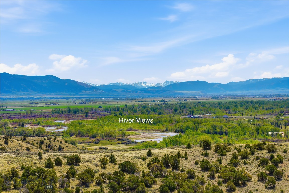 River view parcel perched atop the prestigious Gallatin River Ranch. This exceptional 20+/-acre homesite offers some of the most breathtaking views in the Gallatin Valley. Enjoy sweeping panoramas of the Gallatin River, valley floor, and multiple mountain ranges including the Bridgers, Hyalite, Gallatin, Spanish Peaks, and Tobacco Root Mountains.
This highly sought-after River View parcel is conveniently located near the ranch entrance and provides the perfect blend of privacy, scenery, and accessibility. Property owners enjoy exclusive access to premier neighborhood amenities, including  2 1/2 miles private Gallatin River frontage, a picnic pavilion, fire pit, and BBQ area for residents and their guests.
The property allows for the construction of a main residence, guest house, shop and barn, offering flexibility to create your ideal Montana retreat.
Located just outside Bozeman, you’ll enjoy easy access to fine dining, shopping, entertainment, and the vibrant downtown lifestyle, while still embracing the peace and beauty of ranch living. Not all photos are taken from parcel, some are of private nieghborhood amentities. The video is a virtual rending of potential home on parcel. 
Whether it’s the glowing sunrise over the mountains or the unforgettable sunsets across the valley, this remarkable property captures the very essence of why people fall in love with Manhattan.