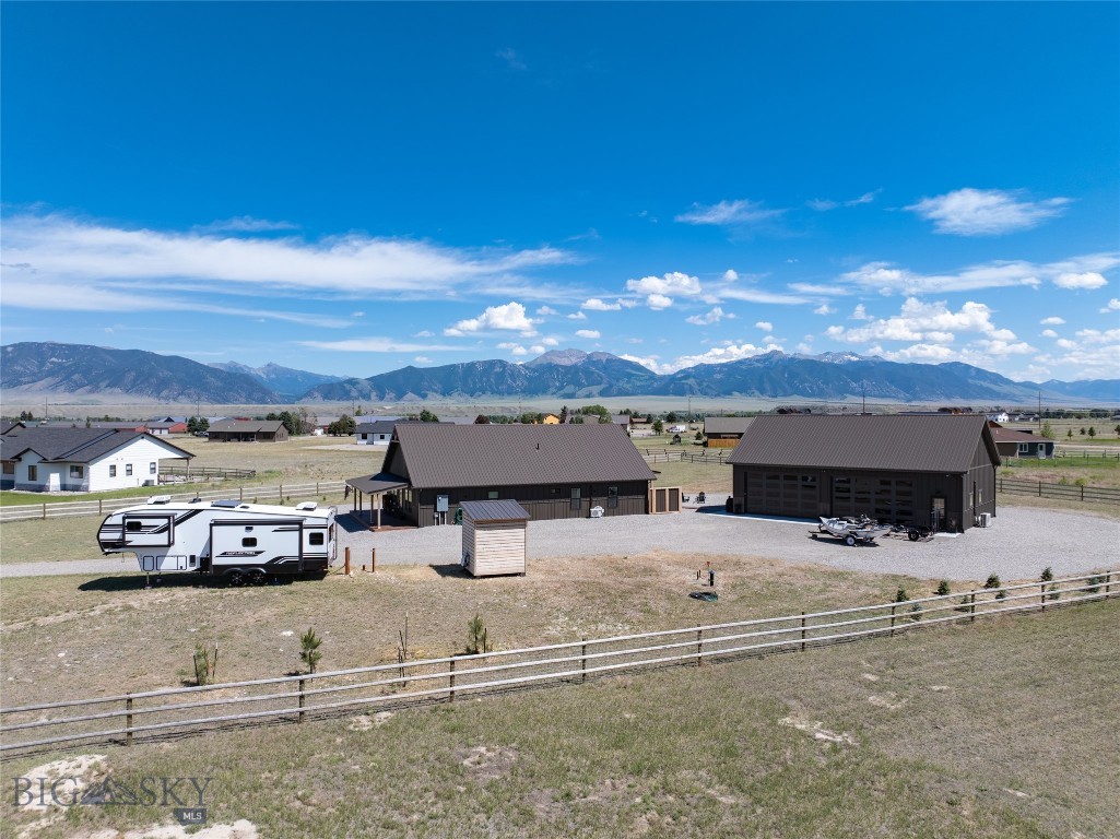 Built in 2024, this single-level shotgun-style home offers an efficient, easy-living layout. Three bedrooms and two bathrooms are arranged along an open floor plan finished with luxury vinyl flooring, carpet in the bedrooms, hickory cabinetry, and quartz countertops. Mini-split systems supplemented with electric baseboard heat keep the home comfortable year-round.
The standout feature is a heated 30x50 shop built with 8-foot custom doors fitted with tinted, insulated, full-length windows — letting light and views in while keeping the interior private from outside. Propane heaters keep the shop functional through winter, and a finished living quarters studio, complete with a 3/4 bath and its own mini-split, adds flexible space for guests, a workshop retreat, or extra income potential.
The driveway has been newly graveled, the yard is perimeter-fenced for dogs, and an RV hookup adds convenience for visiting guests or extra vehicles.
In Sky View, this property offers turnkey one-level living close to town, complete with a shop/garage/guest studio apartment.  Hot tub is included and select furniture may be purchased by separate Bill of Sale.