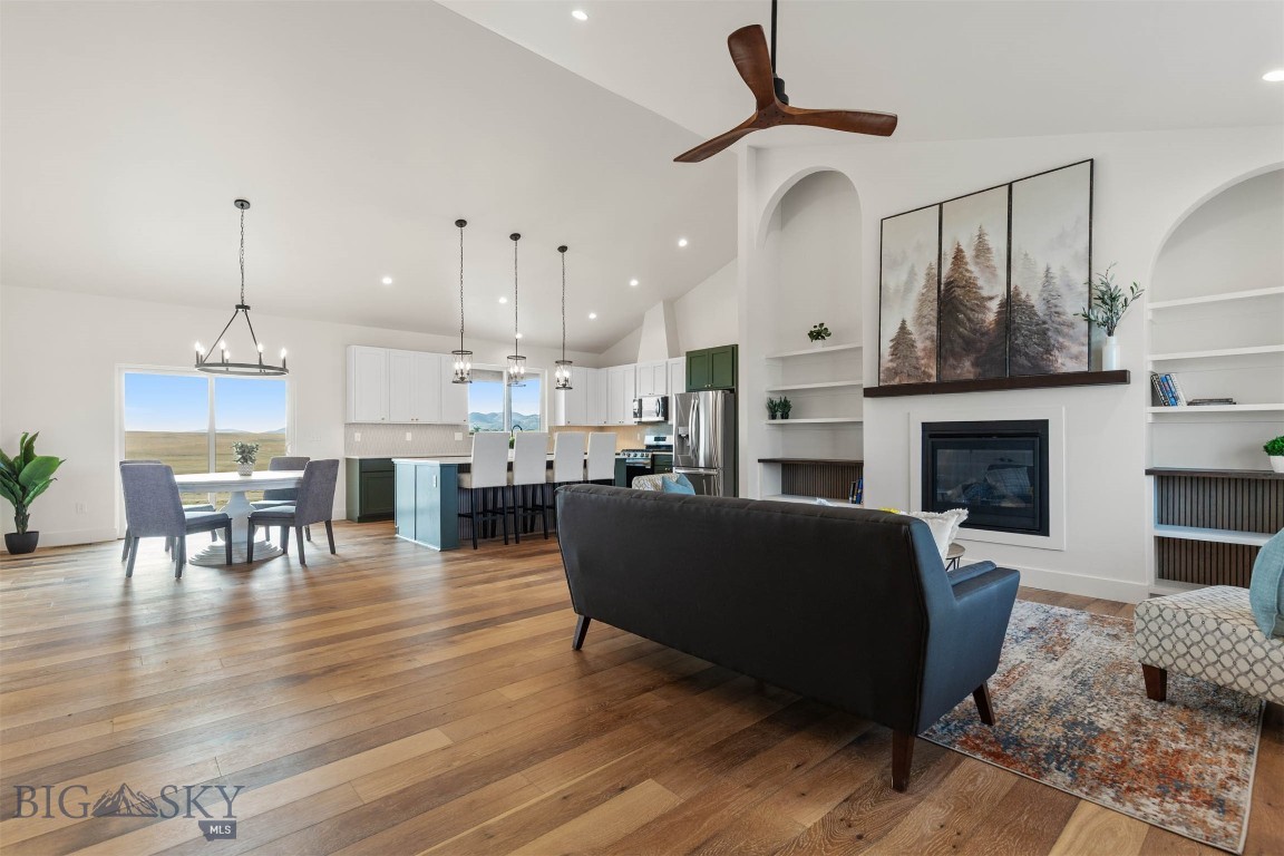 Discover this newly constructed 3-bedroom, 2.5-bath single-level home nestled on 1.3 acres in the desirable Village at Elk Ridge. Thoughtfully designed with tasteful modern finishes throughout, this home offers an inviting, open-concept layout filled with natural light. A stunning fireplace serves as the living room’s focal point, beautifully framed by arched built-ins that add warmth, charm, and custom character. Enjoy sweeping views of the surrounding mountains and valley, with the added bonus of backing to open space for privacy and a peaceful setting.

The spacious kitchen features contemporary cabinetry, quality fixtures, and a bright, functional flow ideal for both everyday living and entertaining. The primary suite provides a comfortable retreat with a well-appointed bath and generous closet space. Two additional bedrooms offer flexibility for guests, an office, or family needs. 

The landscaping will create a welcoming first impression and enhance the home’s clean, modern aesthetic. With ample room to enjoy the wide-open Montana feel, this property delivers a perfect blend of comfort, style, and setting.