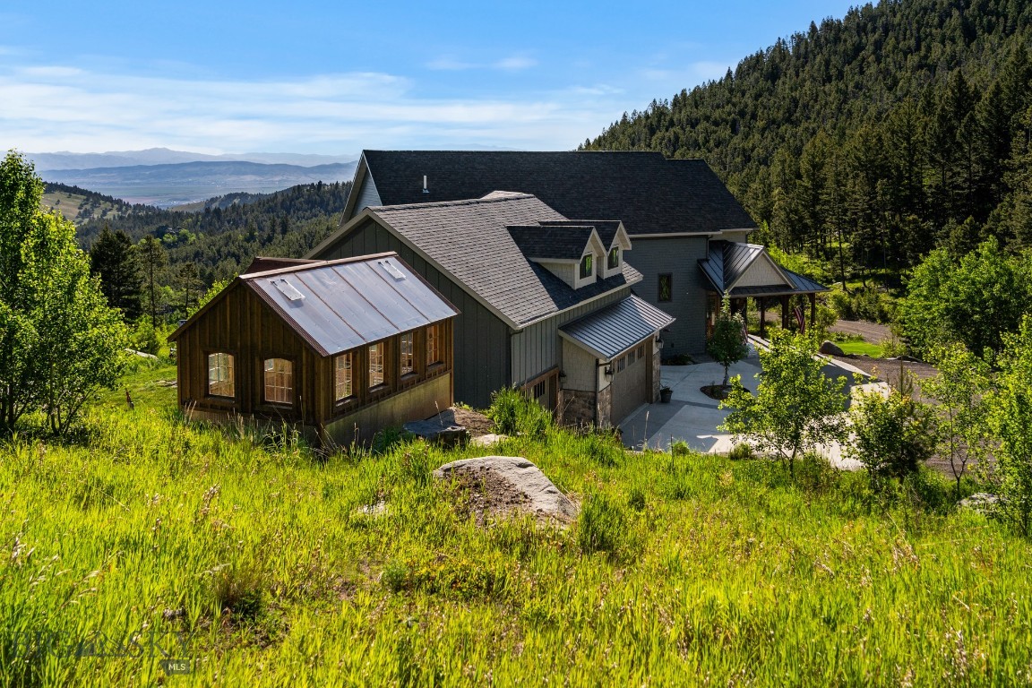 Nestled in the picturesque Boulder Mountain Range, this custom-built home is a testament to luxury living in the heart of Montana. With its unique style and exceptional location, the property goes beyond the ordinary, offering a lifestyle defined by exclusive amenities and breathtaking surroundings. Situated at the end of the road near the top of the mountain and bordered by BLM land on two sides, you’ll enjoy a private outdoor haven with access to thousands of nearby acres to explore. Abundant wildlife, including deer, elk, and moose, frequent the area, with two resident elk herds nearby. Designed and built by the original owner for his family, this well-appointed home reflects a thoughtful balance of luxury, efficiency, and detail, blending rustic Montana character with modern finishes. The home offers 4,861± sf of main living space, complemented by a partially finished daylight basement with an additional 2,840± sf of flexible space awaiting your custom design. The main level features a well-appointed kitchen, dining room, living room with see-through fireplace, master suite, den, bathroom, laundry, mudroom, and a large deck for entertaining. Granite countertops, solid coffee-stained oak floors, maple cabinetry and built-ins, and straight-grained fir trim create warmth and elegance throughout. The primary suite is a true sanctuary with his and her closets, oversized shower/spa room, jetted tub, and coffee bar, plus a private balcony overlooking the valley and Elkhorn Mountain Range views. The second level provides a large seating/TV area overlooking the living room below, a bedroom with connected playroom and 3/4 bath, a full guest bath, an additional bedroom or office, a craft room, and a large bonus room offering flexible space for family, guests, or hobbies. An oversized 3-car heated garage with heated outdoor concrete adds year-round convenience. Just 15 minutes from Helena, enjoy access to urban amenities and the Helena airport, while Great Divide Ski Area is approximately 45 minutes away. The Lewis & Clark National Forest offers year-round recreation including skiing, snowmobiling, fishing, hiking, hunting, and ATV riding. This home offers more than a residence—it provides a luxury Montana lifestyle enriched by nature, adventure, and convenience.