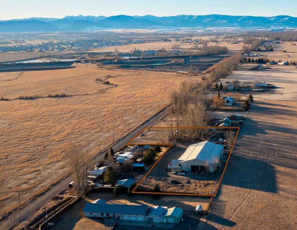 Positioned between Belgrade and Four Corners with convenient access to Interstate 90, this ±13,000 SF industrial facility, including a recently remodeled residential apartment, is unzoned with no covenants, providing flexibility for industrial and operational uses. The building features four 14-foot overhead roll-up doors, ample power capacity, and a functional layout designed to support a variety of needs. The second level includes a living quarters complete with a private bedroom, full kitchen, full bathroom, and private balcony. Sits on 2.4 acres and has Three Phase power.