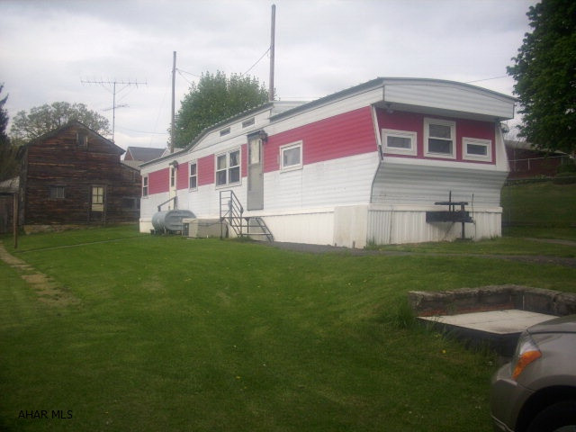Well maintained 1977 12x60 Holly Park mobile home on 0.172 acre. New windows--double hung, double pane with screens. Public sewer, private well that's only 4 yrs old. 2 bedrooms, 1 full bath. All appliances included along with kitchen table and chairs. Central air. 1 car detached garage in front, large outbuilding in rear. Paved drive in front and paved alley in rear of property for additional access. A lot of property at a great price!