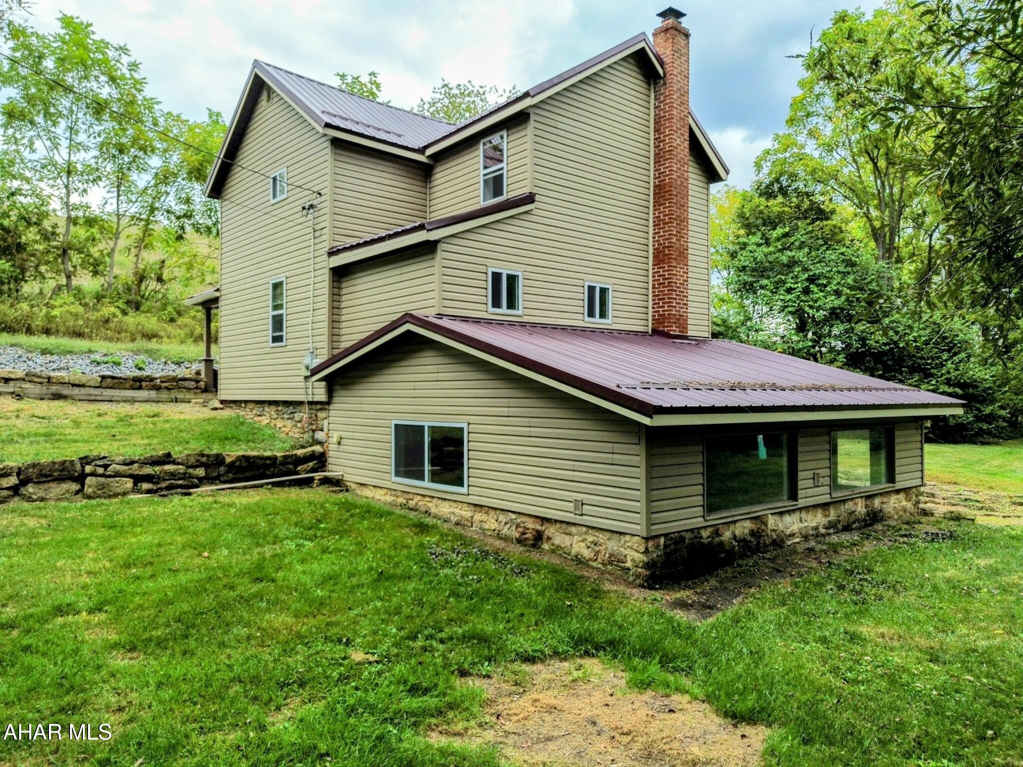 Charming 2-bedroom, 2-bath farmhouse situated on .41 acres in the Bedford School District, set near a peaceful stream and offering the perfect mix of character and comfort. Inside, you'll find a classic oak eat-in kitchen with appliances included. The primary suite features vaulted ceilings and dual sinks, adding both style and convenience. A finished basement rec room with beautiful exposed stone is ideal for entertaining, watching a football game or just relaxing. Come see how this charming home blends comfort, character, and country living and don't miss the chance to make it your own!