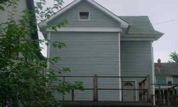 Property to be sold "as-is" - to settle estate.  Exterior is done - newer roof and vinyl siding, some new windows.  100 amp electric.  Interior needs finished.  No furnace. Hot water baseboard units are in place. Large deck.