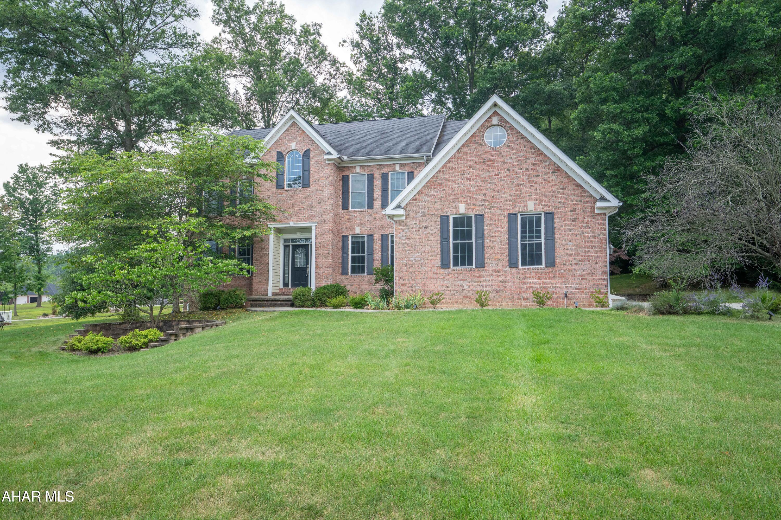 This special home offers many of the features you are searching for!  The welcoming foyer opens to a curving staircase.  Formal dining and living rooms offer hardwood floors for easy maintenance.  The kitchen has been upgraded with new cabinetry and an efficient island with granite counters, stainless steel appliances and eating area.  Nearby is the fully equipped laundry room .    The adjacent family room is warm and inviting with newer recessed lighting, gas fireplace and wall mounted TV for your relaxing evenings.   The second floor features a well appointed owner's suite with two walk-in closets, full bath featuring a jet tub and walk in shower.  Jack and Jill bedrooms 3 and 4 share a full bath.   The guestroom, or 4th bedroom features its own private bath.
The lower level offers a large, carpeted family room with gas fireplace and wet bar - all ready for entertaining family and friends. Additional finished room perfect for exercise equipment, office or playroom.  Large utility room offers ample storage.  Covered patio, three car garage and attractively landscaped lot.  The home is serviced by public water and sewer and equipped with central vac and two heating/air conditioning systems.  Radon remediation system in place.