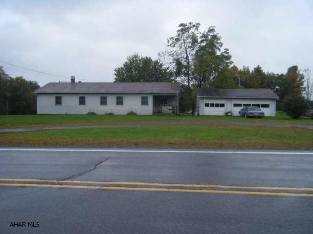 The total acreage of the site is 10.455. The parcel is severed by New Route 22. There is 2.761 acres on the West side of New Route 22. This is accessed by a paved township road. It is low end value property. The main site is 7.694 acres and fronts on Old Route 22 (Admiral Peary Highway). There is a ranch style home, 3 car garage and mostly level terrain.