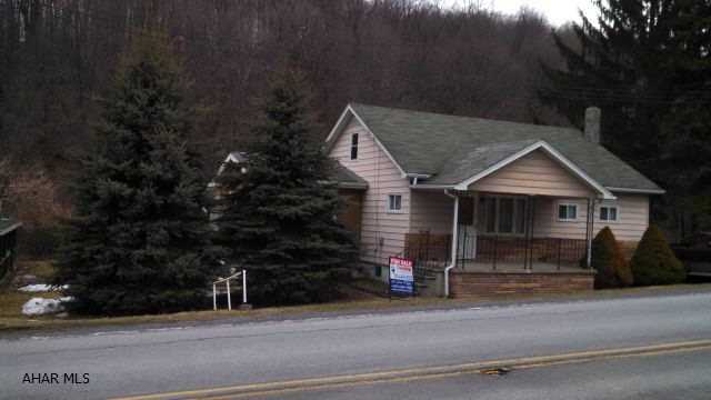 All on one floor! Sunroom, kitchen, living room, bedroom, laundry and full bath. Detached garage. Flowing stream behind property. Private back yard. Covered porch & back patio. City sewer will be installed by 2017. The cost will be $3,000, plus the cost to pipe from the sewer tap to the property. Sweet package for the money.