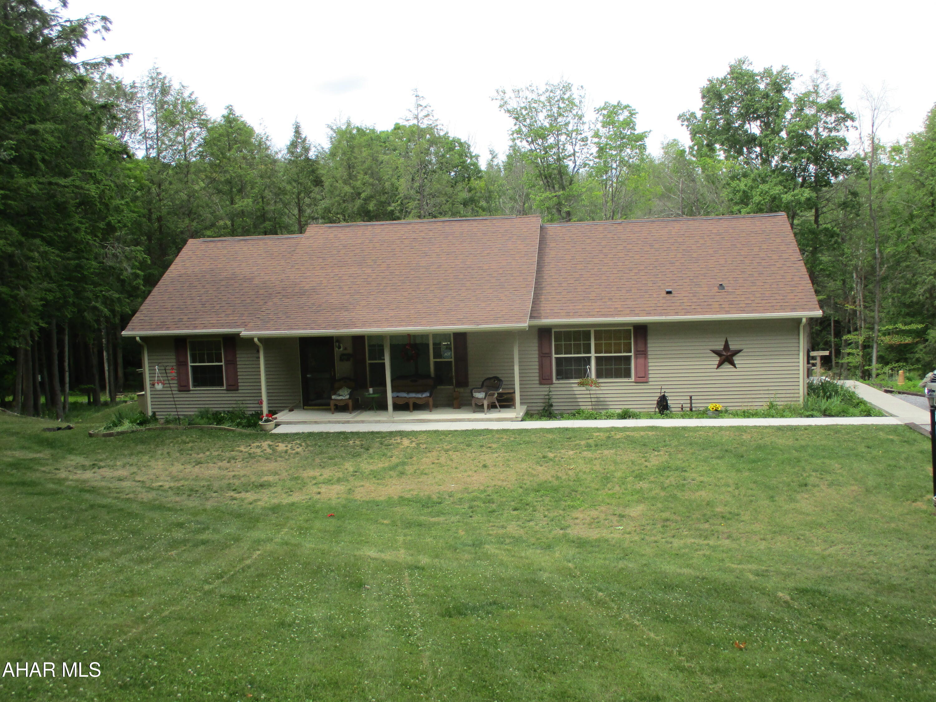 This is a great home located in Chest Township. Lovely 1.6 acre lot in a wooded setting. The house has a 3 car integral garage for parking  inside along with a nice 2 car detached garage and room in the driveway for additional parking. The main floor features a kitchen, dining room, living room, full bath, main bedroom with en suite 3/4 bath. The basement has a man cave for relaxation with a 1/2 bath. The house has flexible heating with oil forced air and heat pump. The home has year round comfort with central air. The property is outside of Glendale Yearound and is able to be part of the association on a voluntary basis (like trash hauling and use of the facilities. The yearly fee is $589.09/year or $196.36/quarter). The air conditioning unit is new as of July 2023. The home comes with a whole house generator. This is a wonderful opportunity! This could be your home!