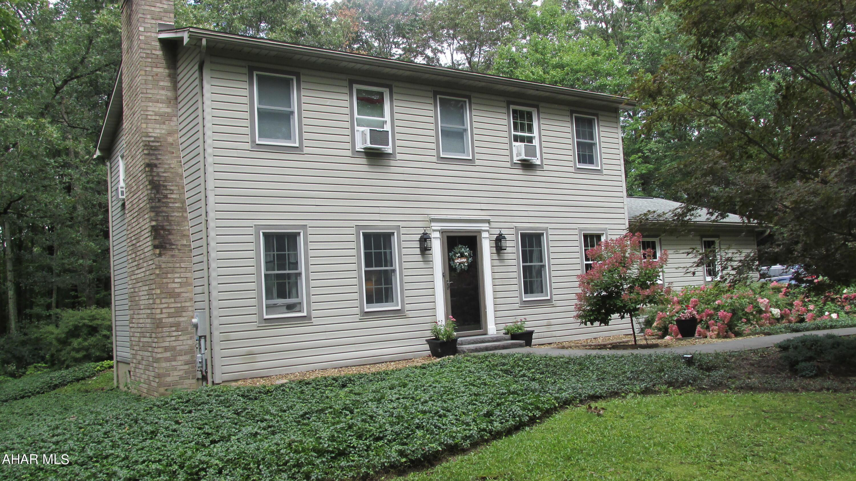 Lovely, private setting for this 2 story traditional with attached garage. Nicely positioned on a 1.12 ac in the Linnwood Development.  This well kept home offers hardwood floors on the first floor and newly carpeted bedrooms, a large eat-in kitchen with oak cabinets, stainless appliances with soapstone counters/subway tile backsplash, formal dining room with atrium door to stamped concrete patio. Living Room with wood burning fireplace. Great first floor laundry & ample closet space. Up - MBR Suite with walk-in closet, 3 additional BR's & Full Bath. Loads of Potential in this unfinished basement. All on a beautifully landscaped lot with stamped concrete driveway. Easy commute to State College or Altoona.