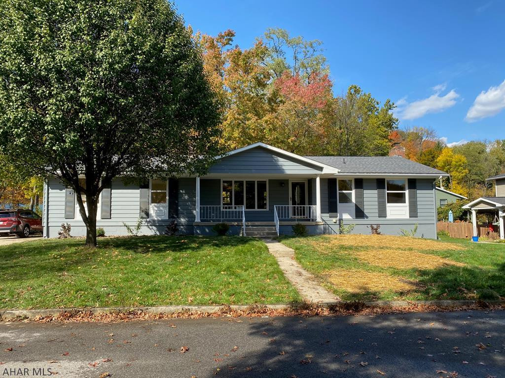 HOLLIDAYSBURG SCHOOLS! Located on dead end street,  totally updated 2-3 bed ranch with 1st floor laundry. Brand new kitchen with granite and stainless appliances. New flooring throughout. New roof and exterior paint.  Gas hot water heat and central air. Enjoy the 3 season sun room or the large new deck on this 100x120 lot overlooking the level back tree lined yard and stream. Beautiful brick fireplace in family room has pellet stove for cozy winter days. Lots of basement storage including room under porch. Double concrete driveway and large 2 car attached garage. If required, seller will pay for 1 year and $500 at closing to plant grass and landscape in spring and seller will add closet if buyer wants to use office/den off living room as 3rd bedrm. Don't wait!