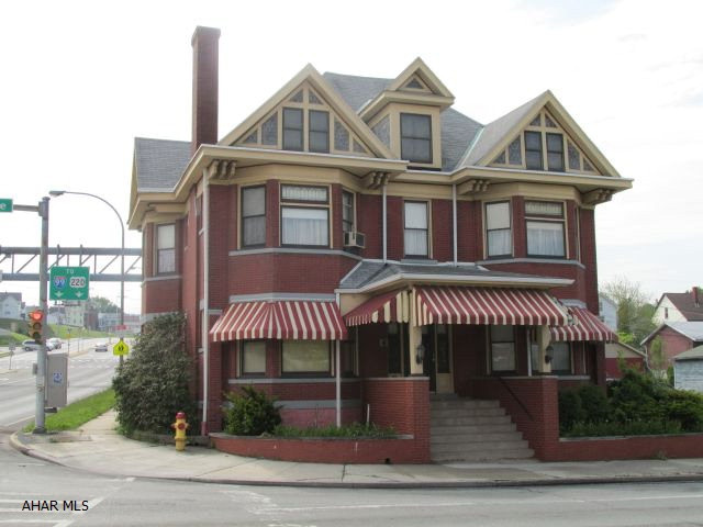 Unlimited potential (seller own almost whole block w/exception of 1711 6th Ave.) Magnifecent building, previously used as a furnal home. 3 finished floors, beautiful woodwork, 2nd floor was living quarters, 3(4) BR, LR, DR, Kit., full bath, sun proch and 2 BR apartment over 3 car garage. LR, DR, kitchen, laundry, sep. entrance and connects to sunporch. Basement full finished area -utility room - laundry hook-up - storage. *See documents for breakdown of taxes. Would make a terrific law office location. Other Tax ID #'s 135,136,137,139,140,141,143.  Motivated Seller - Bring offers!! Terrific business location!!