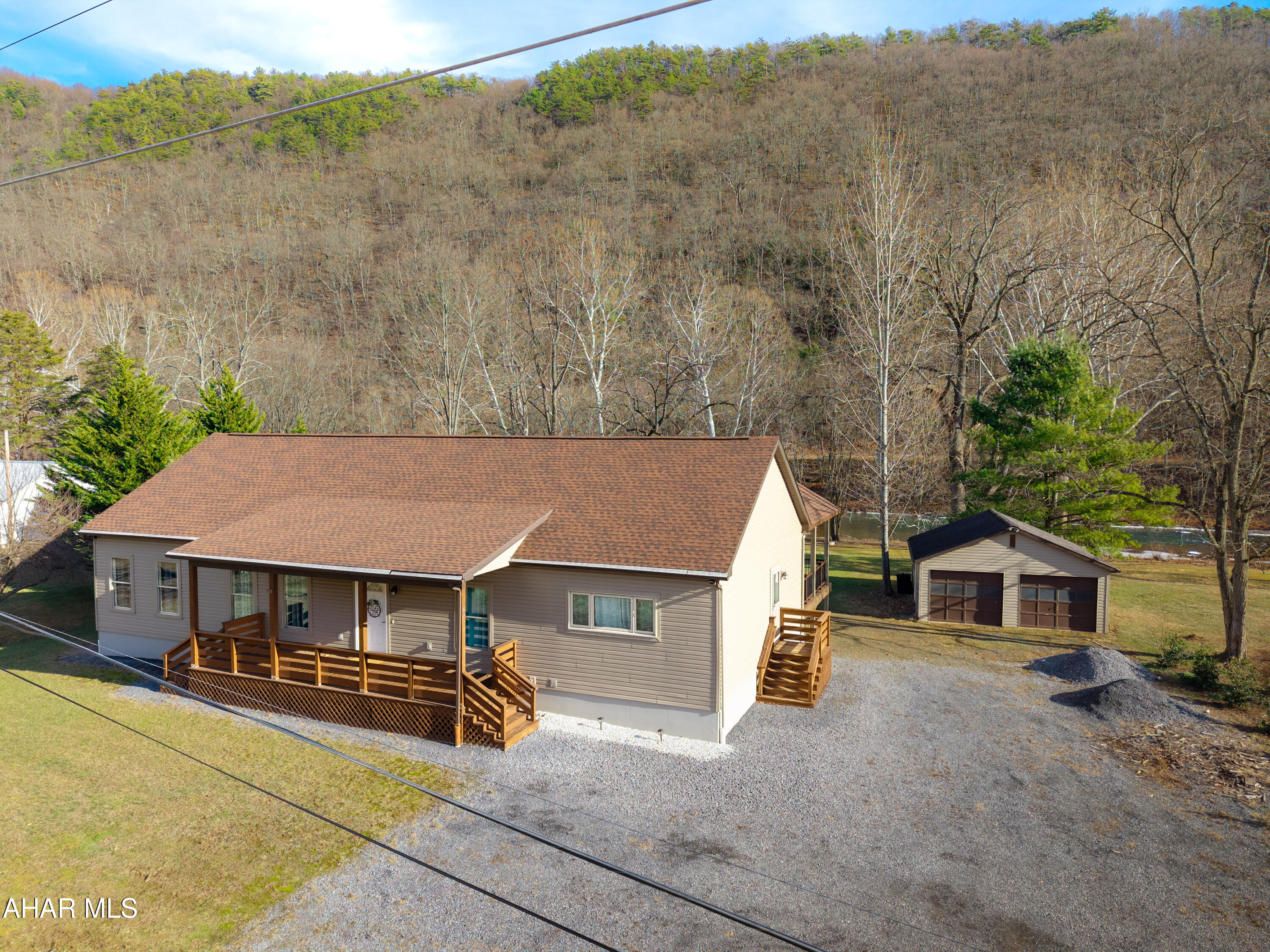 Wake up to the river and unwind by the water! This 3-bedroom, 2-full-bath home delivers the lifestyle people daydream about. Set along the river and just minutes from Raystown Lake, it delivers everyday comfort with instant access to outdoor recreation.

Inside, natural light pours through the home, giving every room an open, easy feel. The layout is practical and welcoming, whether you're hosting friends, working from home, or just enjoying the view with your morning coffee.

Out back, a newly added deck extends the living space and makes the most of the river setting, making it perfect for grilling, relaxing, or watching the water roll by. The house is NOT located in a flood zone, offering peace of mind without sacrificing waterfront living. A detached 2-car garage - heated & cooled - provides plenty of room for vehicles, toys, and lake gear.

If you're looking for peaceful riverfront living with quick access to Raystown recreation, this one checks those boxes, and then some.