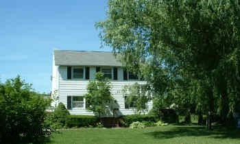 1st Fl. set up as photography studio-great for any business-2nd floor is large modern, 2BR apt. with separate laundry room. Very large master BR. Great landscaping with small pond. Home is well insulated. Newer windows and vinyl siding, new furnace. Foot of Ten Elementary School. Contact listing agent for additional info. Survey on file.