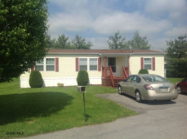 Clean as a whistle, this double wide is move in ready. 3 BR, 2 full baths, all appliances stay. Just bring your funiture and move in. Lot rent is $389.00 and includes water/sewer, snow removal and trash. Off street parking for 2 cars and a shed in the private back yard.