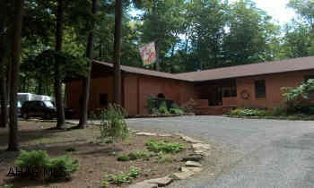 Stunning & Spacious brick ranch on 1.25 secluded acres. Lush landscaping w/ exterior lighting. Sunken Great room w/cathedral ceilings. Large MBR suite w/ walk-in closets, French doors in LR open to rear covered deck, gorgeous views from every  Stunning & Spacious brick ranch on 1.25 secluded acres. Lush landscaping w/ exterior lighting. Sunken Great room w/cathedral ceilings. Large MBR suite w/ walk-in closets, French doors in LR open to rear covered deck, gorgeous views from every window! Detached Cedar garage & 2 story cedar shed. 400- ft sweeping drive-thru w/ample RV parking. Newly remodeled, new roof, new 5-zoned oil hot water heating system. Culligan water purification. Central Vac. Community pool & numerous rec facilities. 1/2 mile to Glendale lake & state gamelands. A must see!
