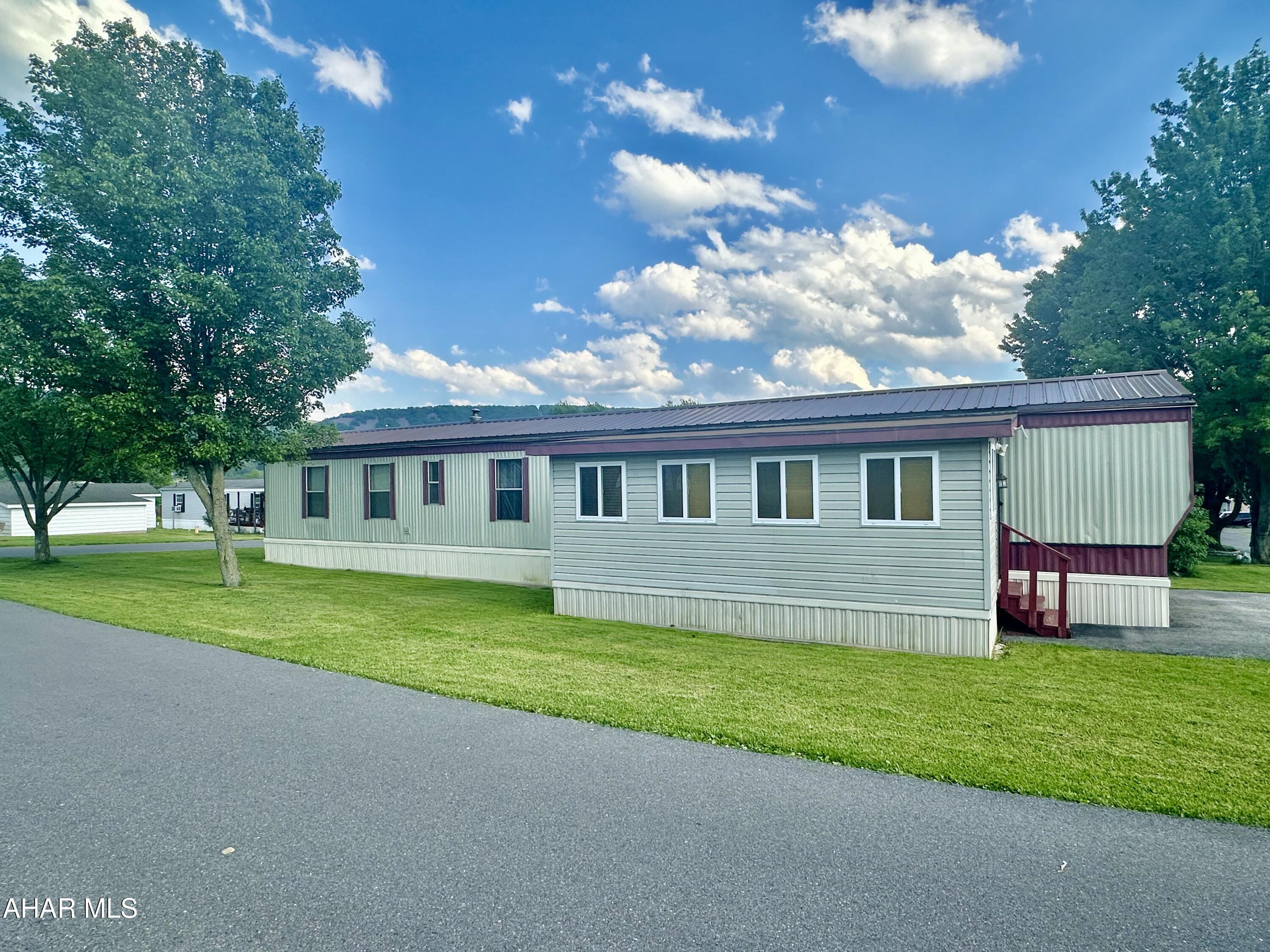 Pristine, Spacious & Immaculate are the words that describe this two bedroom, two bath single wide mobile home located in Greendown Acres Mobile Home  Park.  Laminate flooring throughout, updated kitchen & baths. Laundry  area.  Finished enclosed additional room could be a family room or storage area.  Cozy patio area and a shed for storage complete the outside. New metal roof in 2021. Sun was coming in the windows when photos were taken...new photos coming.