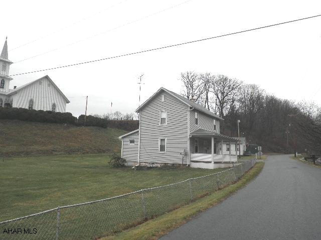 Great small town setting within walking distance of Blue Know State Park & pool. 3-car garage, stg.bldg.,& house.  Underground heat. oil stg. tank. *Real estate taxes are for land only; does NOT include house, garage or bldg.  *Approx. 0.57 acre based on a Dodson Subdivision Plat; NO WARRANTIES ARE IMPLIED.