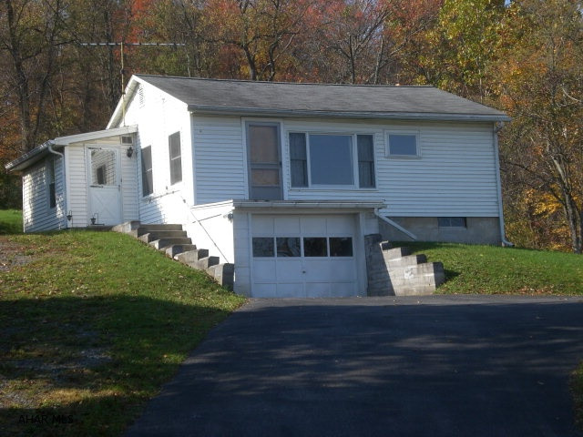 Ranch home in Bedford Township offering two-bedrooms, living room, kitchen and one bathroom.  Full basement with one-car integral garage, oil forced air heat, 100-amp circuit breaker system, public water and public sewer.  Vinyl sided, shingle roof, enclosed porch and macadam driveway.  Large .459 acre lot and nice views.  Great location close to all amenities and roads.