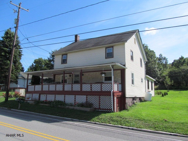 Spacious home on half an acre with large covered deck and wrap around porch, 2 sheds.