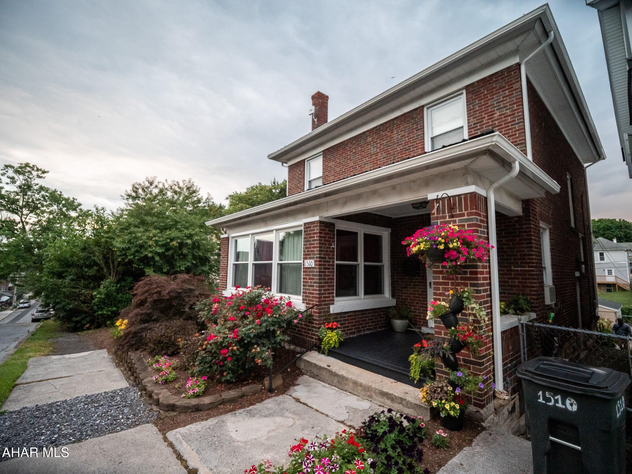Beautiful Brick Home - 3 Bedrooms, 2 Bathrooms, 1-Car Garage with Fenced Double Lot and Outdoor Living Spaces.

Welcome to this charming 3-bedroom, 2-bathroom brick home offering 1,500+ sq. ft. of living space and a perfect blend of character and modern updates.

Inside, you'll find beautiful hardwood floors throughout and inviting, light-filled rooms. The main level includes a cozy kitchen, a welcoming living room, and a dining room with a coffee corner. A bonus sunroom adds additional living space, perfect for relaxing or entertaining.

The full basement (partially finished) features full bath, full-height ceilings, and convenient access to the covered back porch, providing a versatile area for storage, hobbies, or future finishing.

From the dining room, step out onto the 14' x 24' deck, ideal for entertaining or enjoying
your morning coffee. From there, make your way to the backyard retreat featuring a 17 ft.
circular patio with a sitting wall. This thoughtfully designed outdoor space is perfect for gatherings, summer barbecues, or evenings around a fire pit. The yard also offers room for a vegetable or flower garden, making it a peaceful escape right at home.

Recent updates and extras include:
- New roof (4 years old)
- Water heater replaced (2 years ago)
- One off street parking space in addition to the garage
- Stove and microwave included
- Professionally landscaped front and back yards with vibrant flowers and greenery
- String lighting on the deck for warm, inviting evenings
- Low Taxes

This home is move-in ready and offers the perfect combination of indoor comfort and
outdoor enjoyment.