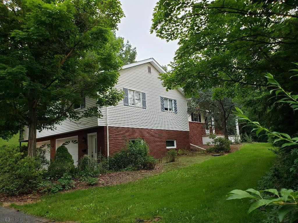 Beautiful home with so many options (can be used as a 3-bedroom home with a 2-bedroom Inlaw suite), updated kitchens, 3 baths, some hardwood floors, sunroom, integral garage and 26x24 detached garage with unfinished 2nd floor (There's room for 6 cars!) Nice private 3.97 acre wooded setting located approx 1.25 miles to I-99. J-416