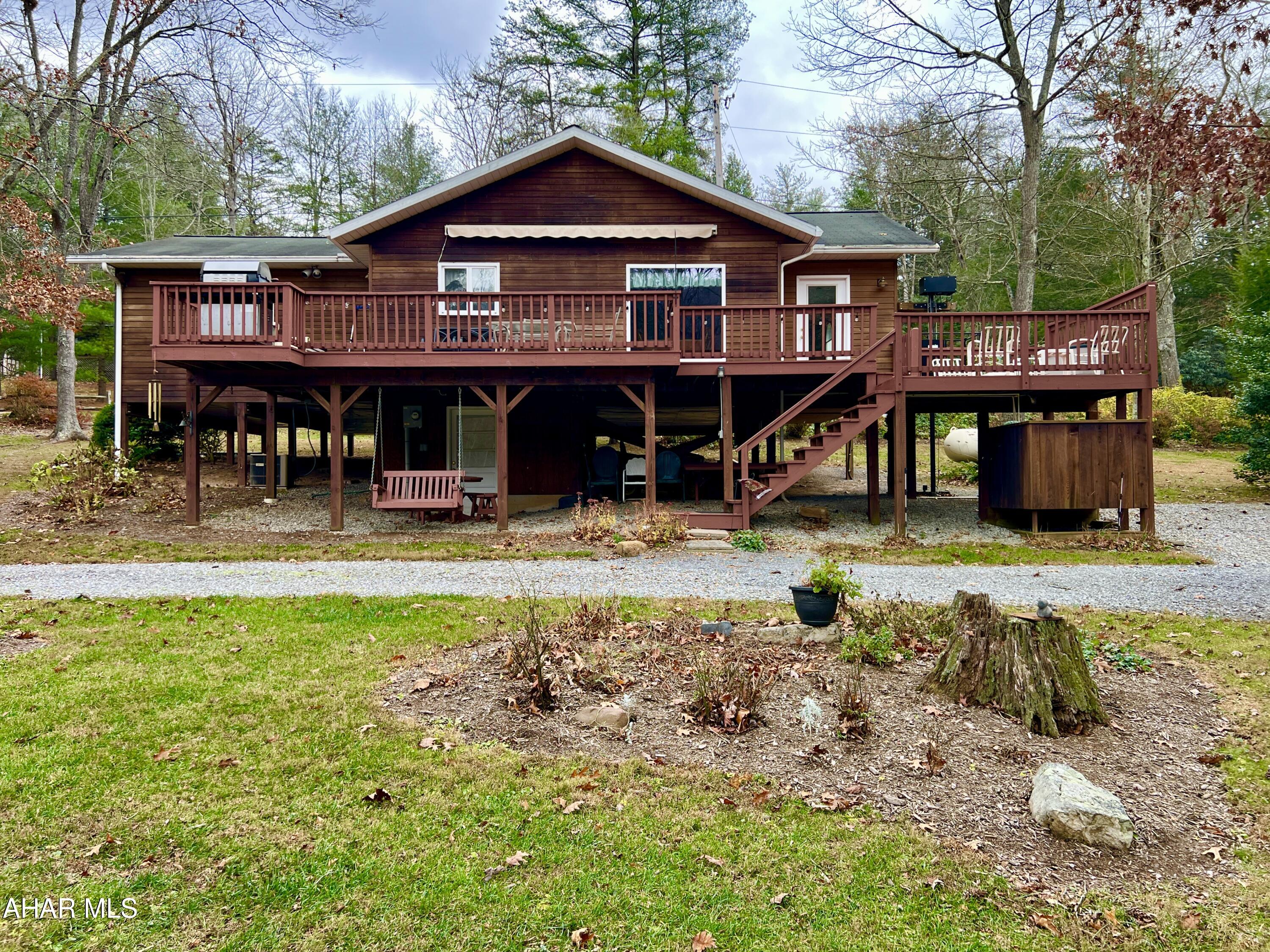 This charming cedar cabin offers a perfect retreat or full-time residence with stunning frontage along the Juniata River. Featuring 4 bedrooms and 2 bathrooms, the home provides comfortable living spaces to sleep, including a spacious living room, dining area, modern kitchen, and convenient laundry area. Step outside onto the large deck with a retractable awning and enjoy the beautiful river views, ideal for relaxing or entertaining guests. The property is equipped with a 500-pound lift to the main level, an outdoor shower, a generous yard, and a shed for storage. Most interior, exterior, and shed items will convey with the sale, making this a turnkey property ready for immediate enjoyment.
