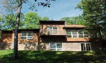 Unique contemporary/ranch w/sunken LR offering beautiful view. Vaulted ceilings, gameroom w/bar. New carpets throughout. Lots of closet space. Fantastic neighborhood, private back yard . Contractor to finish ceramic tile around whirlpool tub in bath and repair/replace tile in basement area.  Also deck to be resealed all contactors equipment will be out of house soon.  Any questions please call Aimee.  937-1878