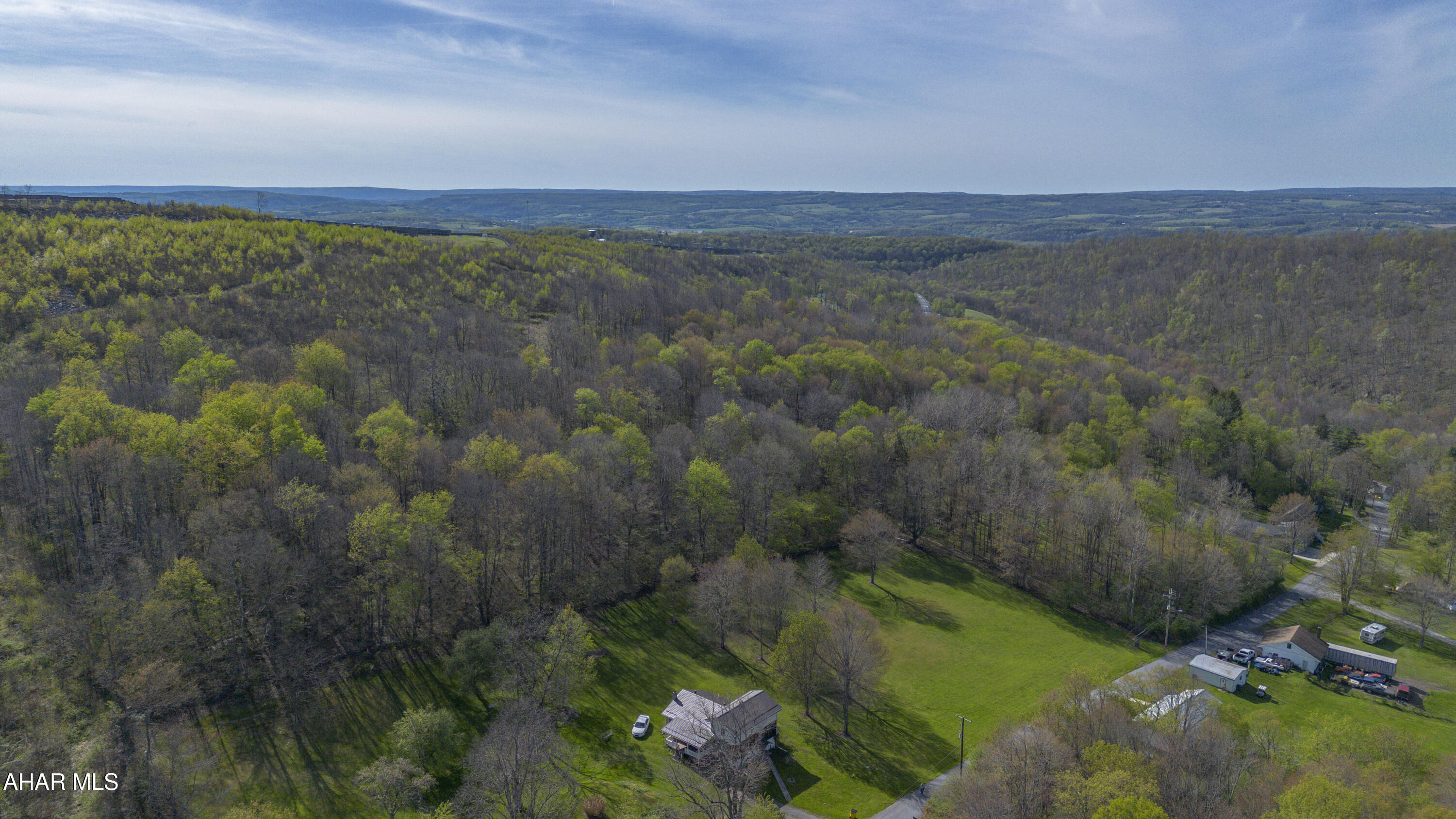 These stunning 13 acres offer the ultimate escape into nature, perfectly positioned to capture a magnificent view from the top of the hill.  Whether you envision building your custom dream home, establishing a premier hunting retreat, or simply creating a private weekend playground, this property provides unparalleled versatility.  The 1.3 acre site is already cleared and ready for construction.  Attention investors: with multiple potential build sites and the option to divide the property, these parcels present an excellent development opportunity. All utilities are available at the street. A large portion of the land is available for timbering. A beautiful stone wall adds character and charm to the landscape.