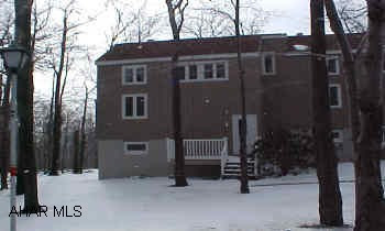 Updated condo - 1st Floor Unit - New siding, windows, carpet, pergo floor, gas fireplace - Rental info available - Sleeps 6 - Assoc Dues $334.40 Super 1st Floor Unit - End Unit - Non Smoking - with patio appliances, some furnishings, satellite, right on hole #9 of Golf Course, Cross Country ski trail.  Guests may use tennis courts, sauna, jacuzzis & swimming pools.