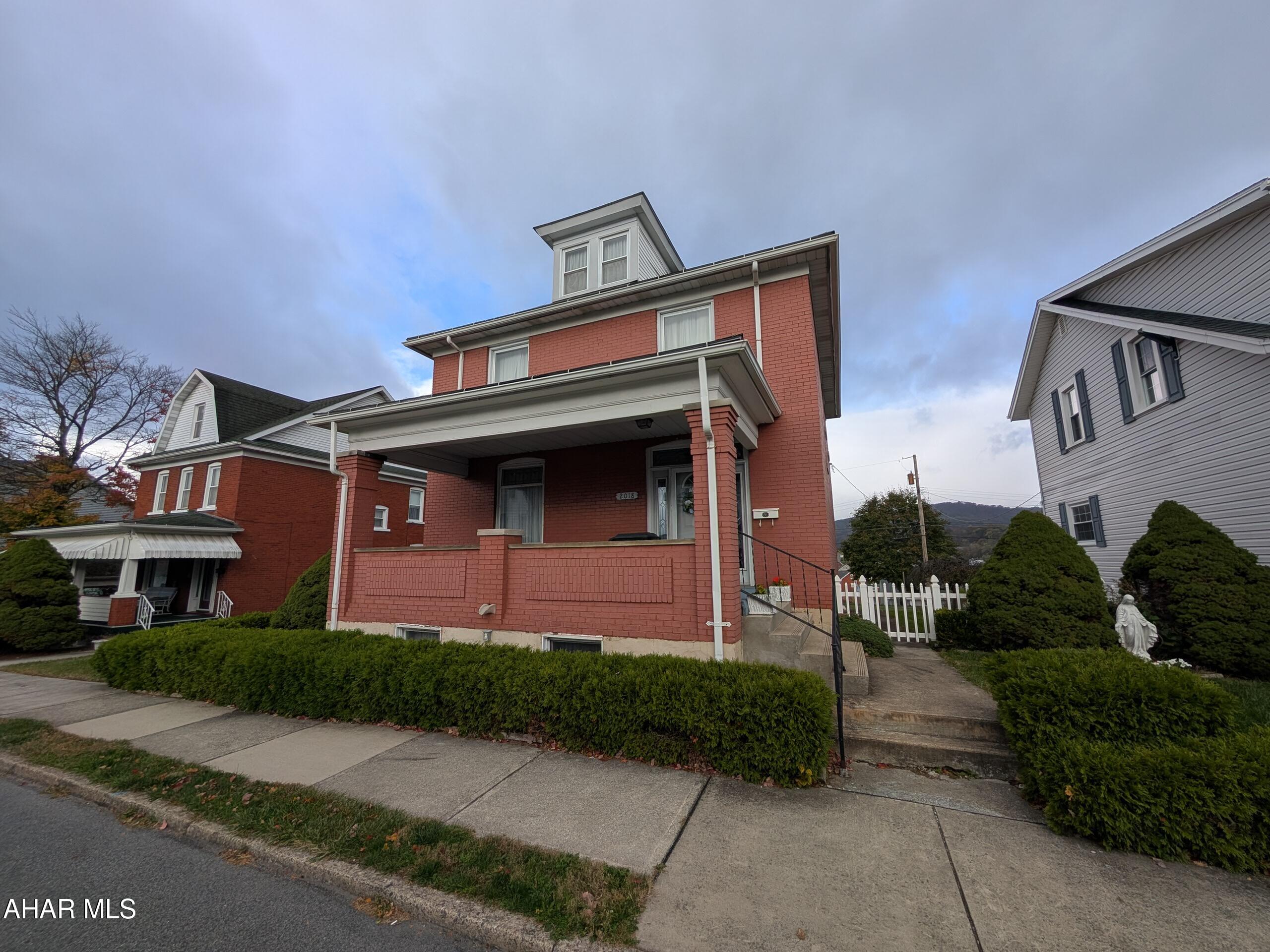 Spacious 2-story brick home in Altoona's desirable Garfield Park neighborhood! This charming residence offers 4 bedrooms, 1.5 baths, along with a beautiful entry foyer, bright formal living room and dining room—perfect for entertaining. The fully equipped eat-in kitchen features solid surface countertops, large pantry and plenty of workspace. The finished walk-out basement adds even more living area, including a cozy family room with gas fireplace, half bath, laundry, and utility room. Enjoy beautiful mountain views from the large covered rear deck, or relax on the inviting covered front porch. Fenced yard with rear alley for possible off-street parking. Ample storage in walk-up attic. Schedule your tour now!