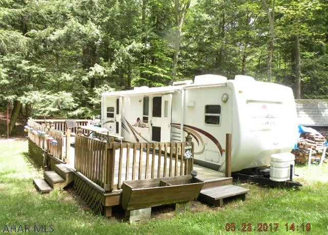 Nice 30 ft Cedar Creek camper on 2 lots w/ stream in back. Deck, shed & grill included. Well maintained, includes all amenities of GYR, swimming pool, tennis courts, basket ball & volley ball courts. Minutes from State Park, state game lands & Rock Run ATV trails