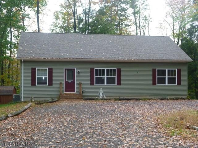 Nearly new home on over an acre surrounded by woods in a gated community.  Enjoy being out in nature but with all of the perks of a community.  One story home with three bedrooms and two full baths on the main floor, includes a master suite.  The kitchen was made for cooking, baking or just eating.  The large island has ample storage as well as a great work surface.  Since the kitchen is open into the living room and dining area it is a great space for family or entertaining.  Full bath and laundry are in the spacious basement but there are also laundry hookups on the first floor.  Heat pump supplies you with both heat and central air. This home is located in Glendale Yearound, a gated recreational community adjacent to Prince Gallitzin State Park / Glendale Lake and State Game Lands 108.