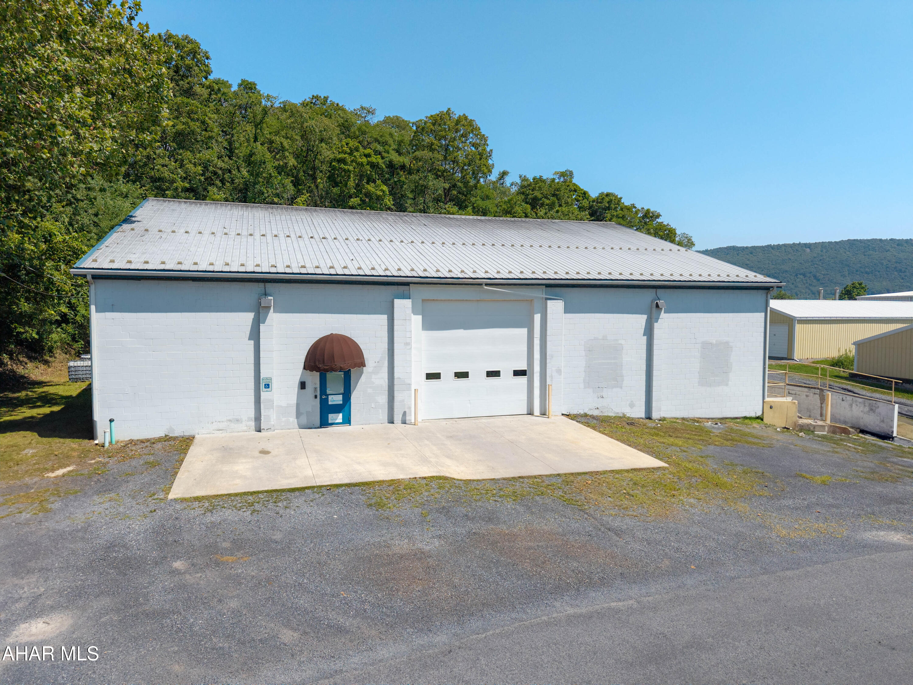 This is a rare find!! Warehouse building with office space situated just outside the Bedford Borough!! Building contains 7,240 square feet with two ground level overhead doors and one truck loading dock. Warehouse space is heated with zoned natural gas furnaces. Office space is heated and also has cental air conditioning. ADA accessible, three phase electric, and public water and sewer. Great for warehousing, manufacturing, retail business, office space, art gallery, winery, brewery, repair garage or vehicle storage. Located in Bedford Township with no zoning, this building has many uses. Off-street parking in front and also the rear of the building. Convenient location close to the downtown Bedford area, major roads, and other amenities.