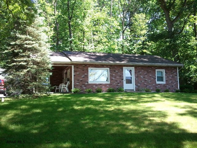 One - story, vinyl sided home in a nice section of Tyrone. Close to school and hospital. Large covered patio in back (very private), covered side porch, finished room in basement, all appliances and kitchen window coverings stay. Detached, 2 car garage and black-topped off street parking. Priced to sell at $99,900. Qualifies for a rural housing loan. (no money down)