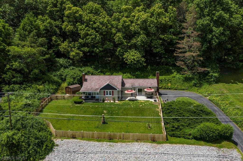 The welcome mat is out for this cozy move-in ready home with numerous upgrades, conveniently located close to Southside Elementary. You're sure to love this charming 3 bedroom home, ideal for a year round residence or a second home, only 10 minutes from Raystown Lake. The living area has a Vaulted ceiling with sliders to the new patio area, great for outdoor entertaining with a large fenced in yard.  The luxury vinyl plank flooring in the living room add to this spacious room adjacent the newly remodeled kitchen with granite counter tops. Enjoy the view drinking your morning coffee at the bar in the kitchen.  The newly renovated bedroom on the second floor is sure to please with tongue and groove and hardwood flooring. Don't miss the adorable new 3/4 bath in the basement. You'll love it!