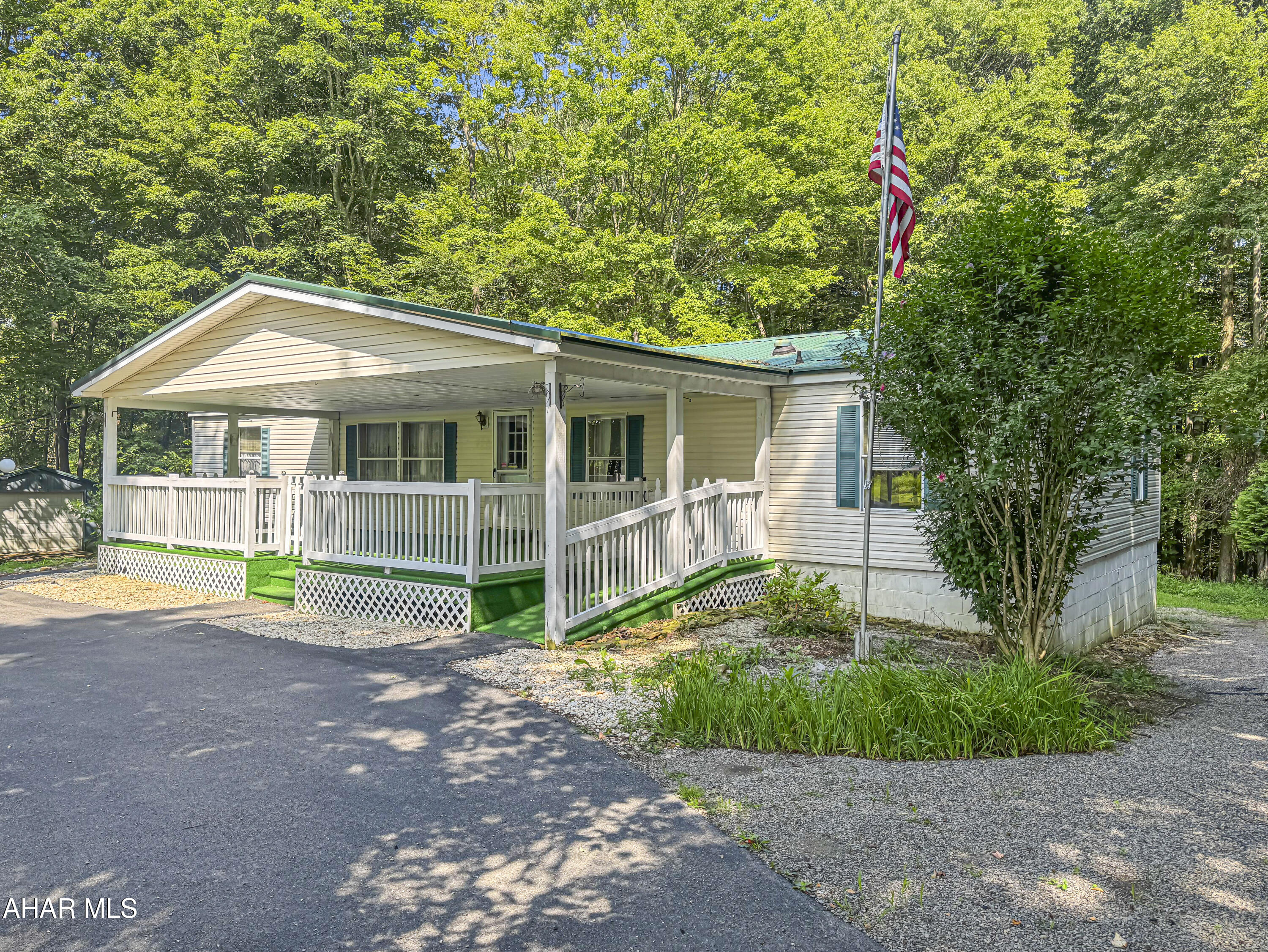 Welcome to 496 Vic Miller Road in the Blacklick Valley School District! Discover this beautifully maintained double-wide home, expertly situated on a full basement & nestled on a peaceful 1.2-acre wooded lot. As you step inside, you'll be welcomed by a spacious family room that flows seamlessly into a fully remodeled kitchen. The main floor also features a generous living room, laundry area, two comfortable bedrooms, & a full bathroom. The highlight is the master suite, complete with a walk-in closet & a private full bathroom. Although the basement isn't directly accessible from the main floor, its high ceilings open up a world of potential for use as a workshop, finished living space, or extra storage! This home has been thoughtfully modified for handicap accessibility, ensuring comfort for everyone. Outside, you'll find a newer metal roof, a wraparound paved driveway, three large sheds for all your storage needs, & an incredibly private setting loaded w/ potential. Don't miss out on this fabulous opportunity! Call today to schedule your visit!