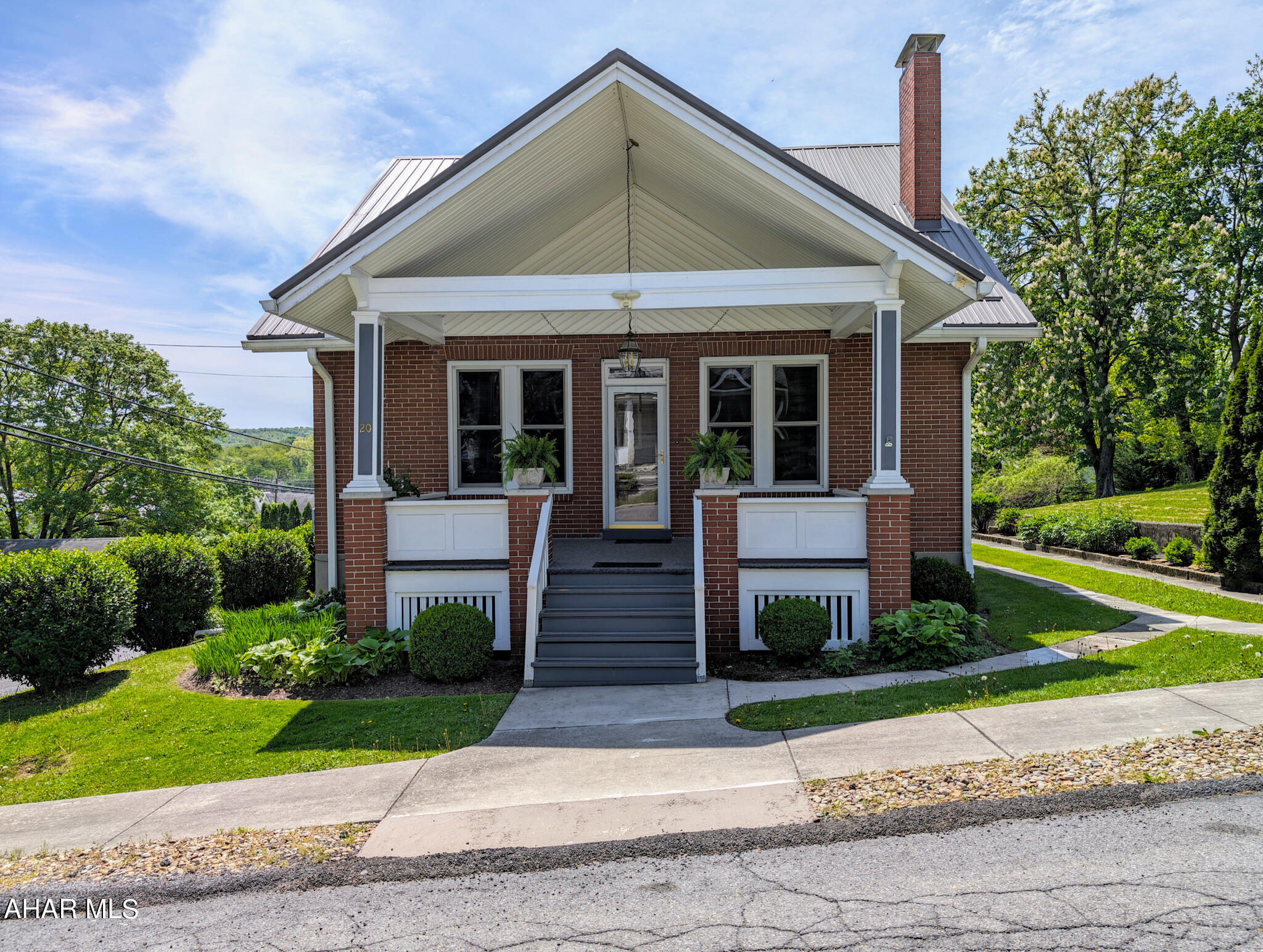 If you're looking for the ease of town living, but space enough for a yard, you've found your home. Located at 20 West 2nd Street in the great town of Everett sits a brick and vinyl cape cod that will wow you. This home has been meticulously cared for! Pristine oak and tile floors throughout entire home, and cherry built-ins give this home the warmth it deserves. A large covered front porch invites you into a cathedral ceiling of beautifully crafted wood. Three large ceiling fans to keep the air moving in any season, there's also a brick, wood burning fireplace to sit around when the air turns chilly. Original stained glass is the Devroe crest, that ordains the two side windows of the fireplace and haven't moved since their inception. They're a remarkable addition to the cherry built ins that surround the fireplace. Beveled windows throughout are also found on the french doors that open into the dining area. Glass door knobs are the exact character this home needs! A stately tiffany style chandlier hangs from the ceiling while custom blinds and valances sit atop bench built ins for added storage. Plenty of room in the kitchen for cooking and entertaining! The bar can accommodate high top chairs and overlook the kitchen. Black appliances look nice against the cherry stained oak, more custom blinds and valances and a newer garbage disposal. A garage door signal is located in the kitchen so you know if you accidentally left the garage door open! Step out onto the screened in 3 season room that also has an outdoor pantry. Off of the screened in porch is access to the terrace on top of the garage. Proper railing has been installed. Fill this with foliage and flowers and let it be your oasis! Back inside the home the first level offers a main bedroom with closet and its own french doors with access to the 3 season room. The main full bath carries on the cherry cabinets along with custom blinds, valance and shower curtain. Clean and impeccable!
A beautiful oak staircase will lead you to the two bedrooms that each have an alcove that overlook the back yard. All bedrooms with ceiling fans, closets, and the original oak floors. Second story full bath continues with the cherry cabinetry, tile floor, a Jacuzzi tub and stall shower. Laundry tubs and laundry area are located in the basement. A cedar closet, tons of storage area, a half bath and access to the integral garage that will fit one large vehicle or two smaller ones.  A new metal roof with 50 year warranty installed 2022; newer garage door, 2023 the front and back porch were painted and carpeted, and 2022 new water heater. Mature landscaping and ease of entry whether the front, side, back or through garage give you the access you need. This home is close to all the wonderful amenities that Everett has to offer. From walking distance to shops, eateries, gas and groceries, a library, banks, a barber shop, beauty shops, and doctors. Quiet and friendly neighbors are pivotal to loving your neighborhood and home and you will find that right here in the heart of 20 West 2nd Street, so schedule your tour today!